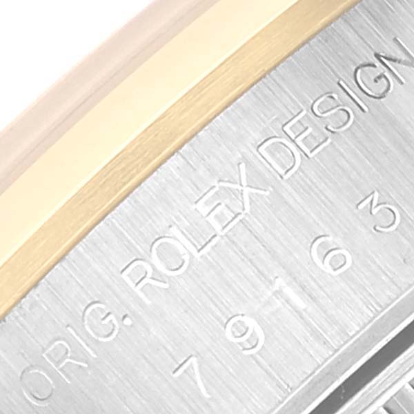This image shows a close-up of the engraving on the case side of a Rolex Datejust 79163 Women's Steel and Gold (two tone) Champagne Dial 79163 Women's Steel and Gold (two tone) Champagne Dial watch.