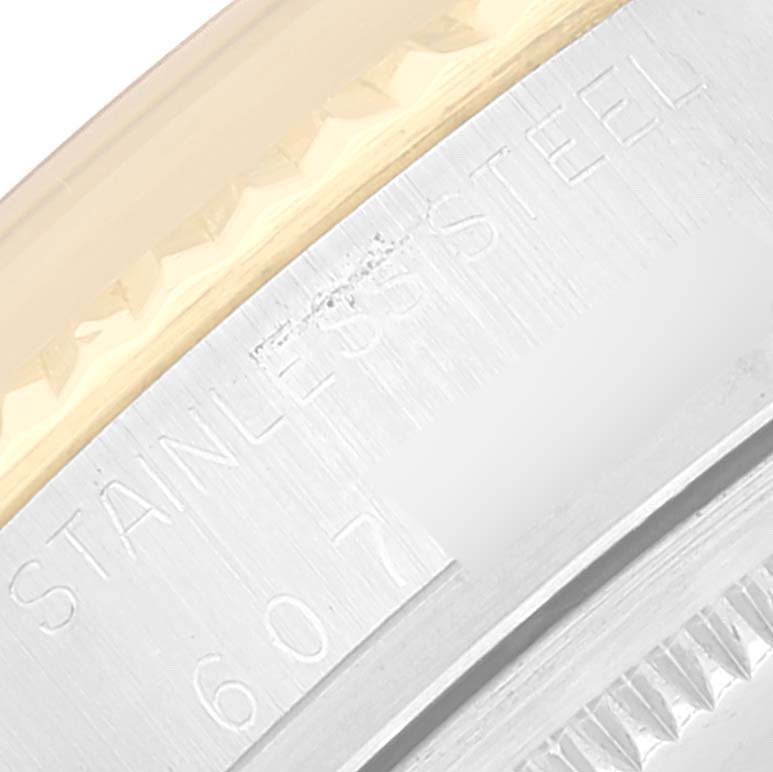 The image shows a close-up of the side engraving on a Rolex Vintage Collection 16013 Men's Steel and Gold (two tone) White Dial 16013 Men's Steel and Gold (two tone) White Dial watch, displaying "STAINLESS STEEL" and part of a serial number.