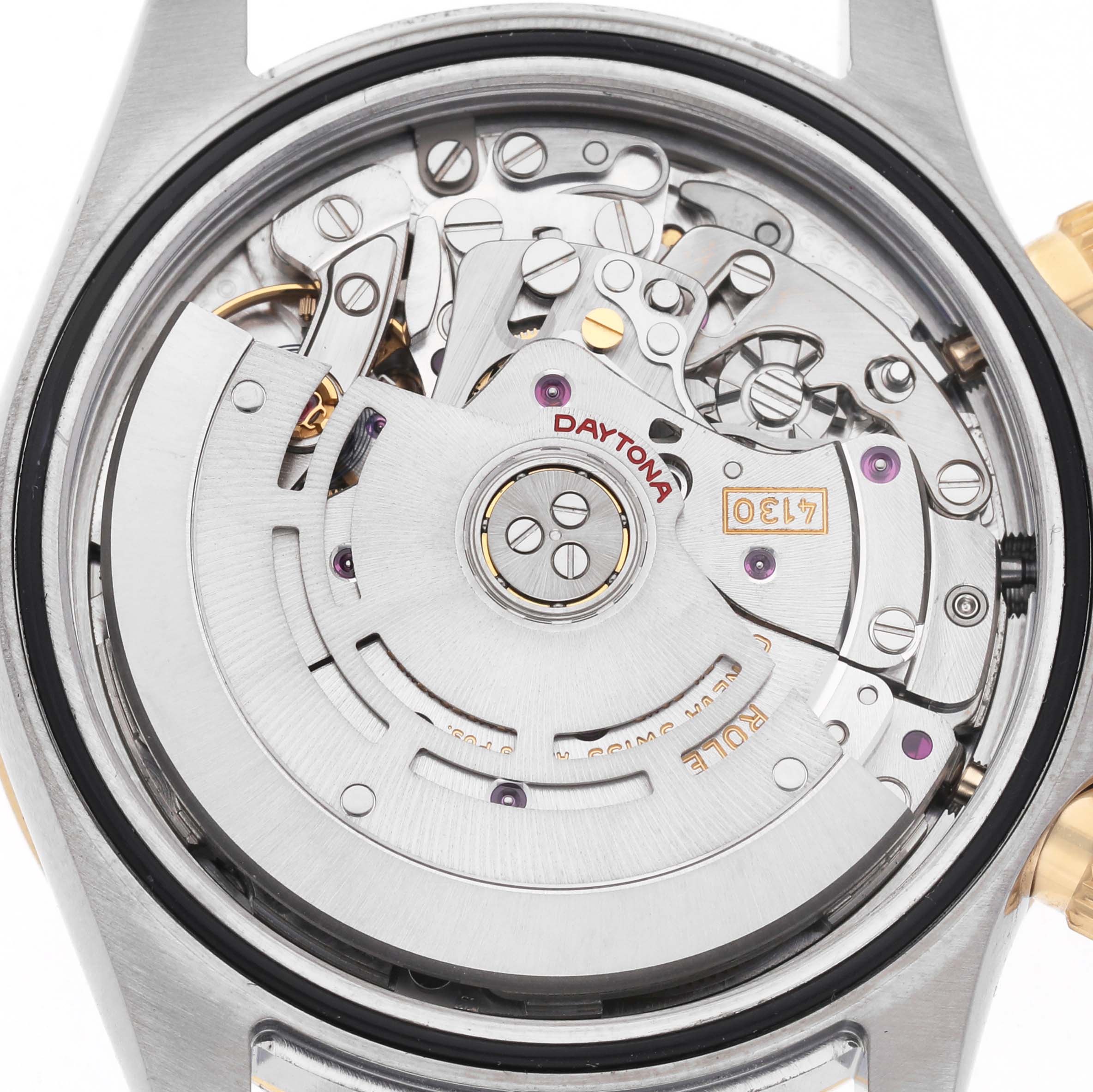 The image shows the internal movement of the Rolex Daytona 116523 Men's Steel and Gold (two tone) Yellow Dial watch viewed from the case back, highlighting its intricate mechanics.