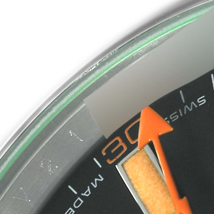 The image shows an up-close view of the 30-minute marker and an orange second hand on the dial of a Rolex Milgauss 116400 Men's Stainless Steel Black Dial 116400 Men's Stainless Steel Black Dial watch.