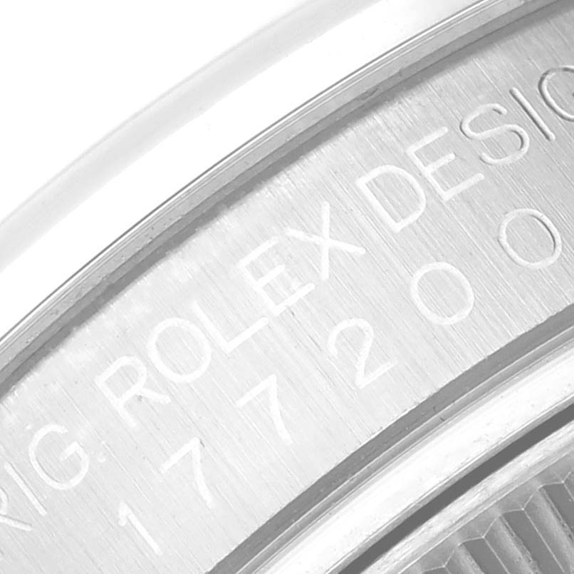 The image shows a close-up view of the engraving on the side of a Mid-Size Rolex watch case.