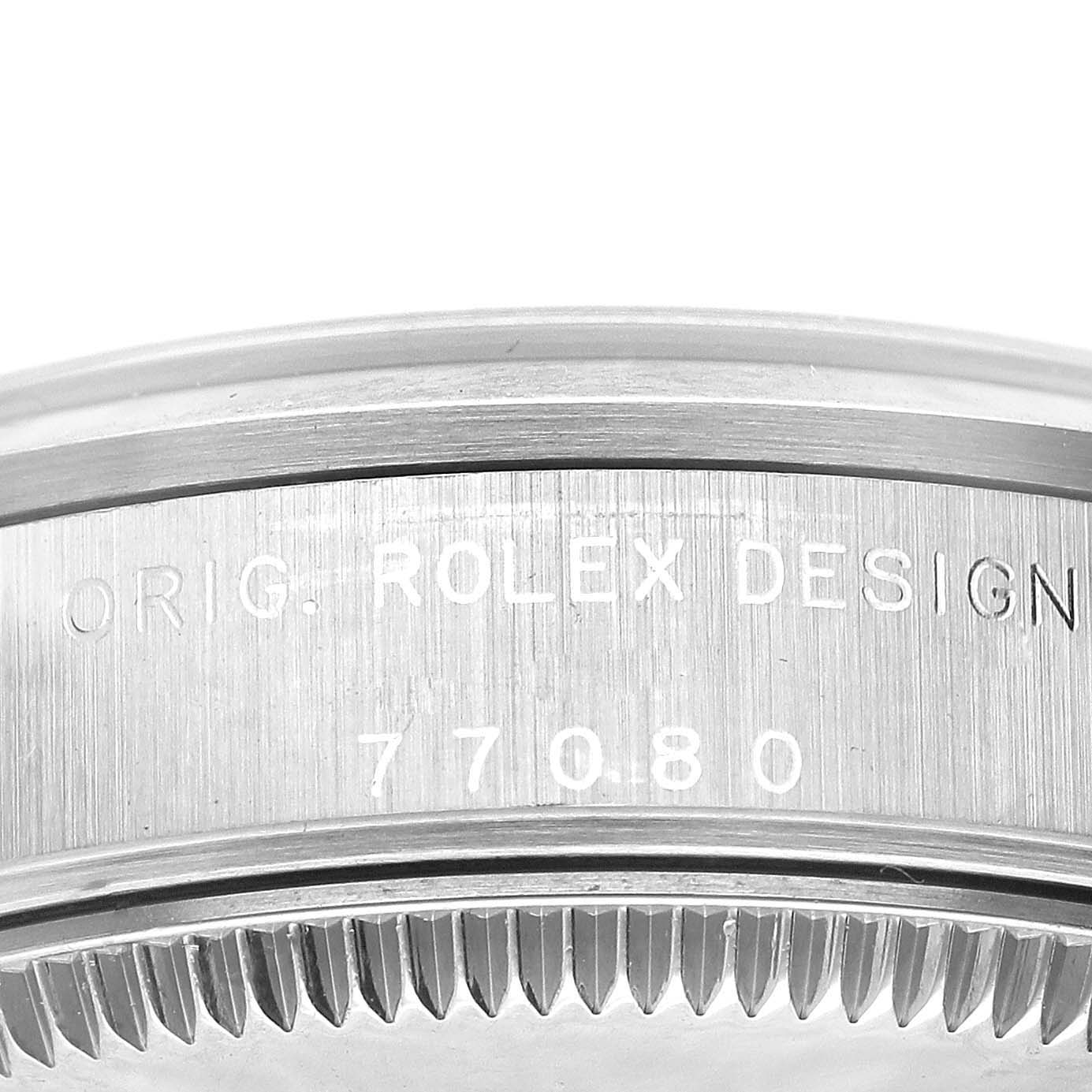 This close-up image shows the side of the Rolex Mid-Size 77080 Women's Stainless Steel Pink Dial 77080 Women's Stainless Steel Pink Dial model with the engraving "ORIG. ROLEX DESIGN 77080."