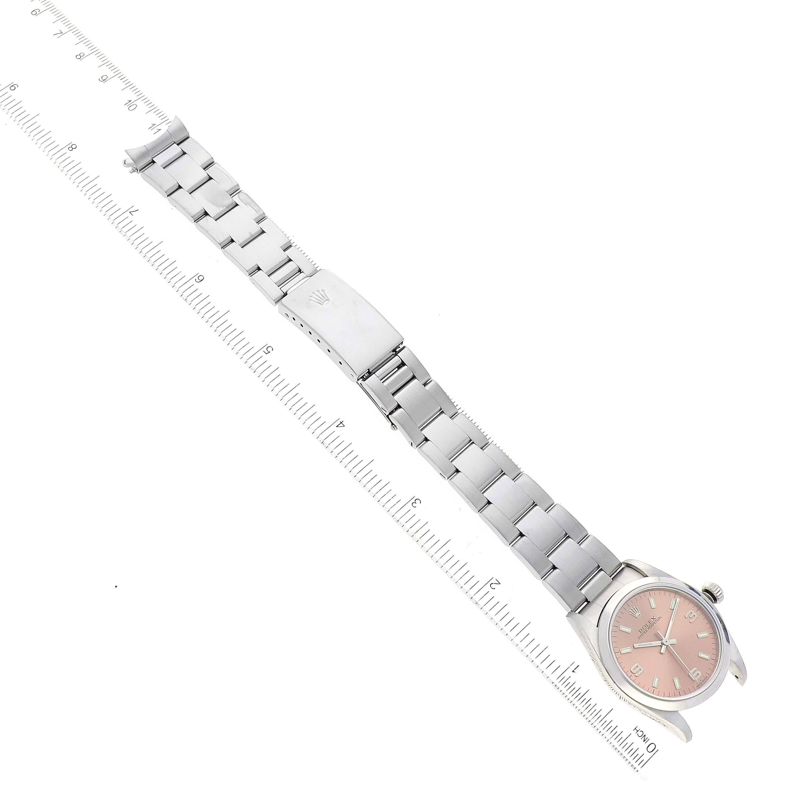 The image shows a Rolex Mid-Size 77080 Women's Stainless Steel Pink Dial 77080 Women's Stainless Steel Pink Dial watch from a top-down angle, highlighting the watch face, bracelet, and clasp.