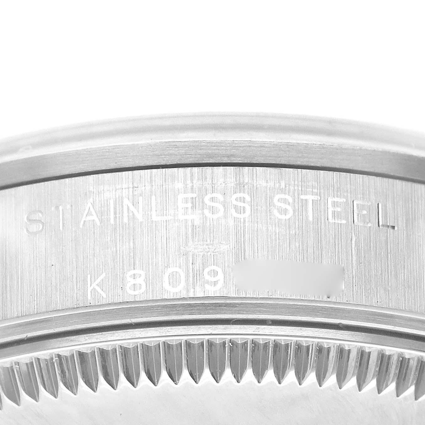 This image shows a close-up of the stainless steel case back and model number engraving for a Mid-Size Rolex watch.