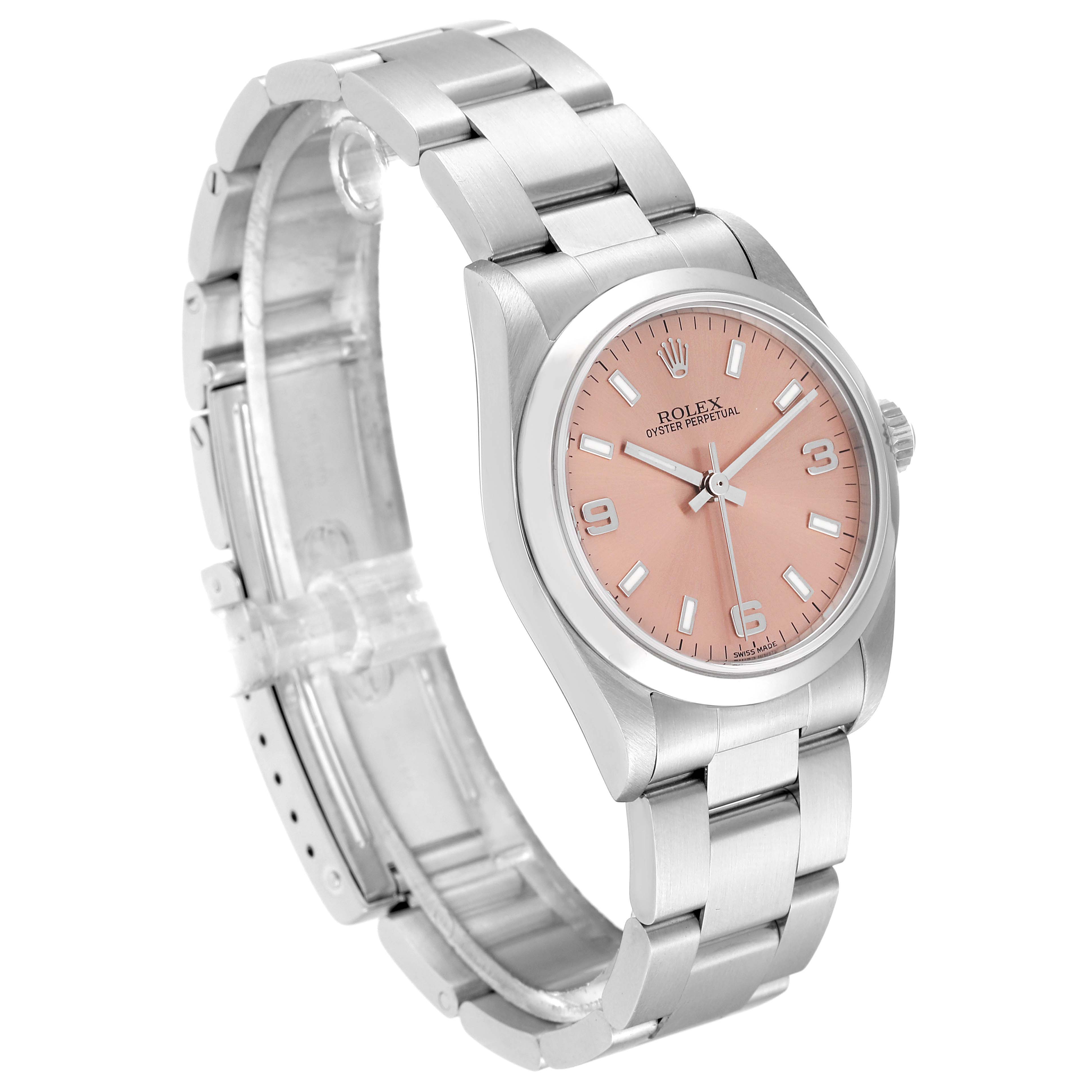 The Rolex Oyster Perpetual Mid-Size watch is shown at a three-quarter angle, displaying its pink dial and stainless steel bracelet.