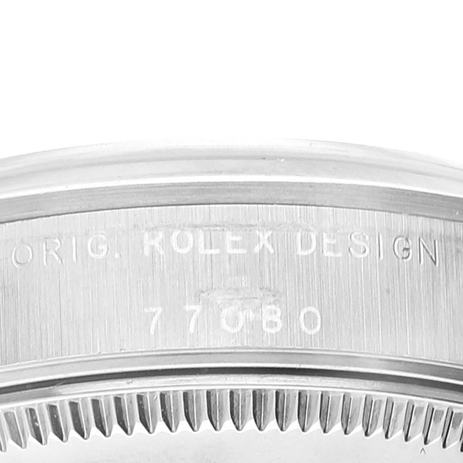 The image shows a close-up of the serial number and text "ORIG. ROLEX DESIGN" on the caseback of a Rolex Mid-Size 77080 Women
s Stainless Steel Pink Dial 77080 Women
s Stainless Steel Pink Dial model watch.