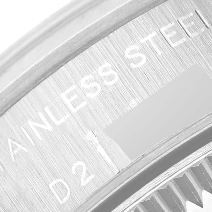 This close-up image of a Rolex Oyster Perpetual 76080 Women's Stainless Steel Silver Dial 76080 Women's Stainless Steel Silver Dial watch shows a partial view of the stainless steel case with engraved markings.