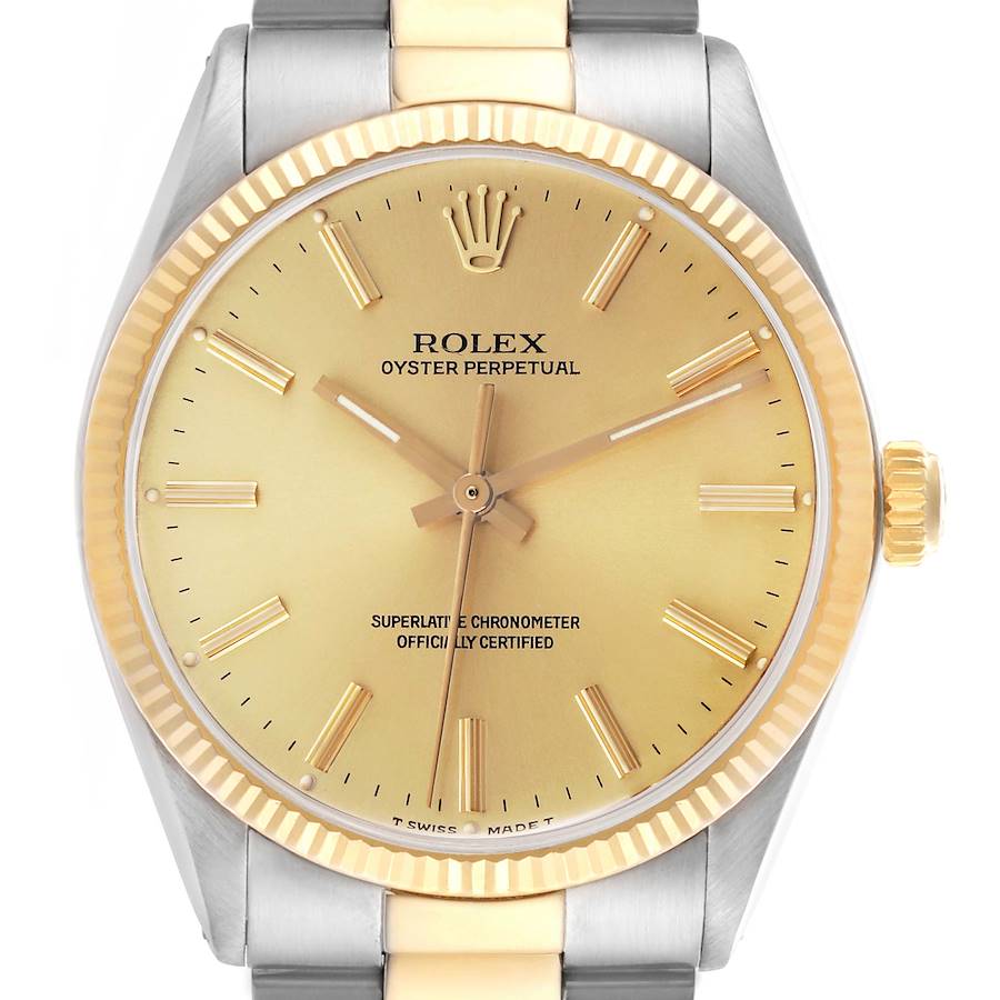 The Rolex Vintage Collection watch is shown from a front angle, highlighting its gold dial, crown, and two-tone bracelet.