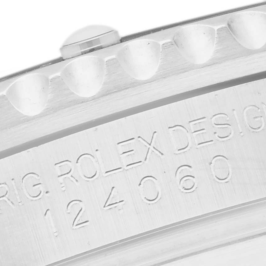 The image shows a close-up angle of the Rolex Submariner 124060 Men's Stainless Steel Black Dial 124060 Men's Stainless Steel Black Dial's engraved case side, displaying part of the design number.