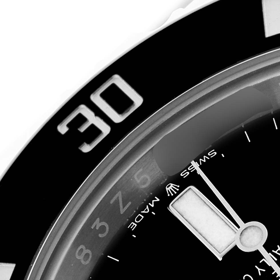 The image shows a close-up angle of the Rolex Submariner 124060 Men's Stainless Steel Black Dial 124060 Men's Stainless Steel Black Dial's bezel and part of the dial, featuring the "30" marker.