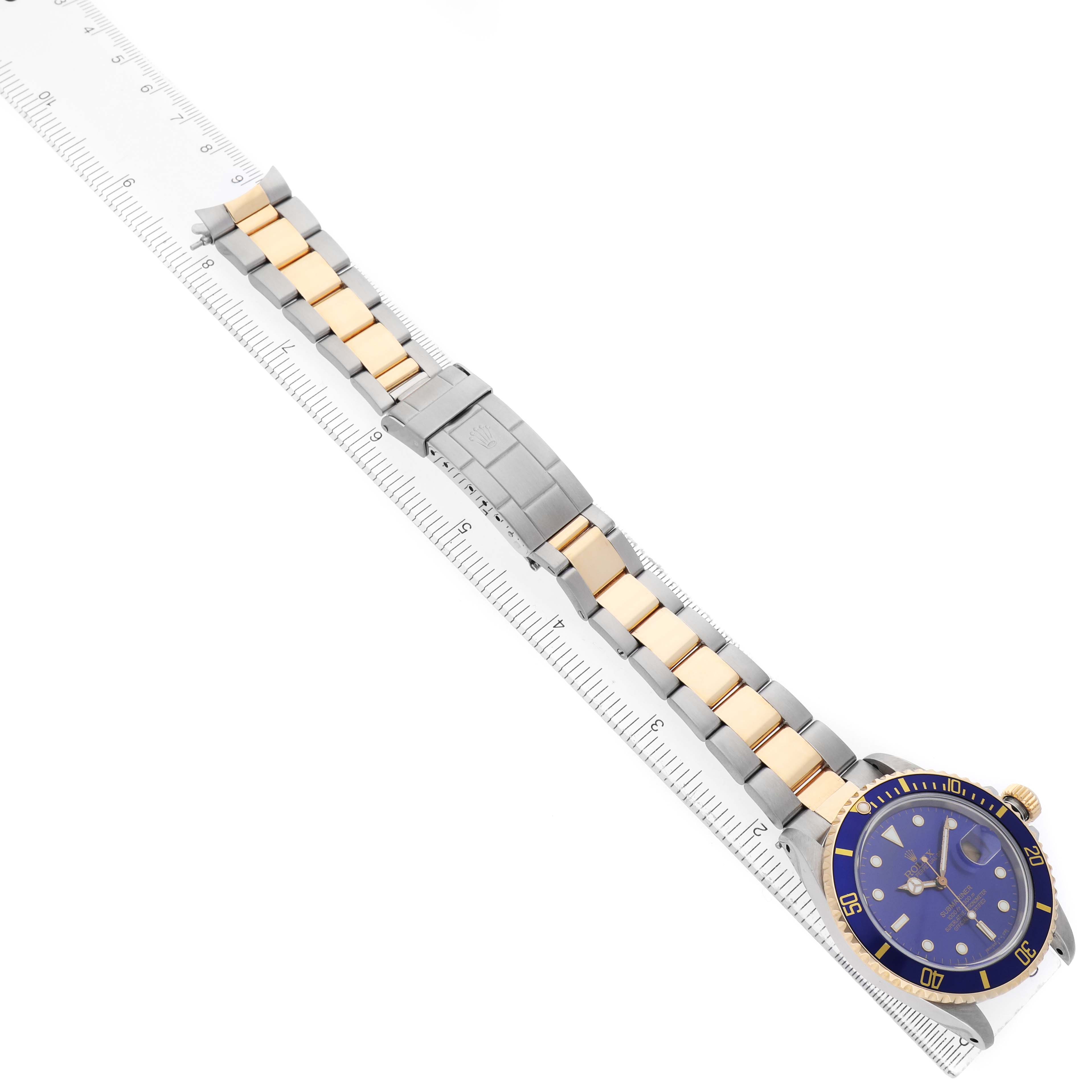 The Rolex Submariner 16803 Men's Steel and Gold (two tone) Blue Dial watch is shown from an angled top view, displaying the face, bezel, bracelet, and clasp.