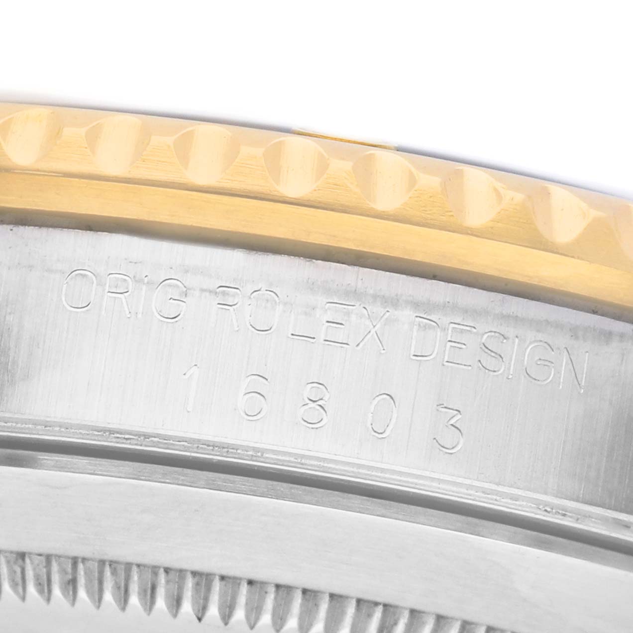The image shows a close-up side angle of a Rolex Submariner 16803 Men's Steel and Gold (two tone) Blue Dial, highlighting the bezel and engraved model number.