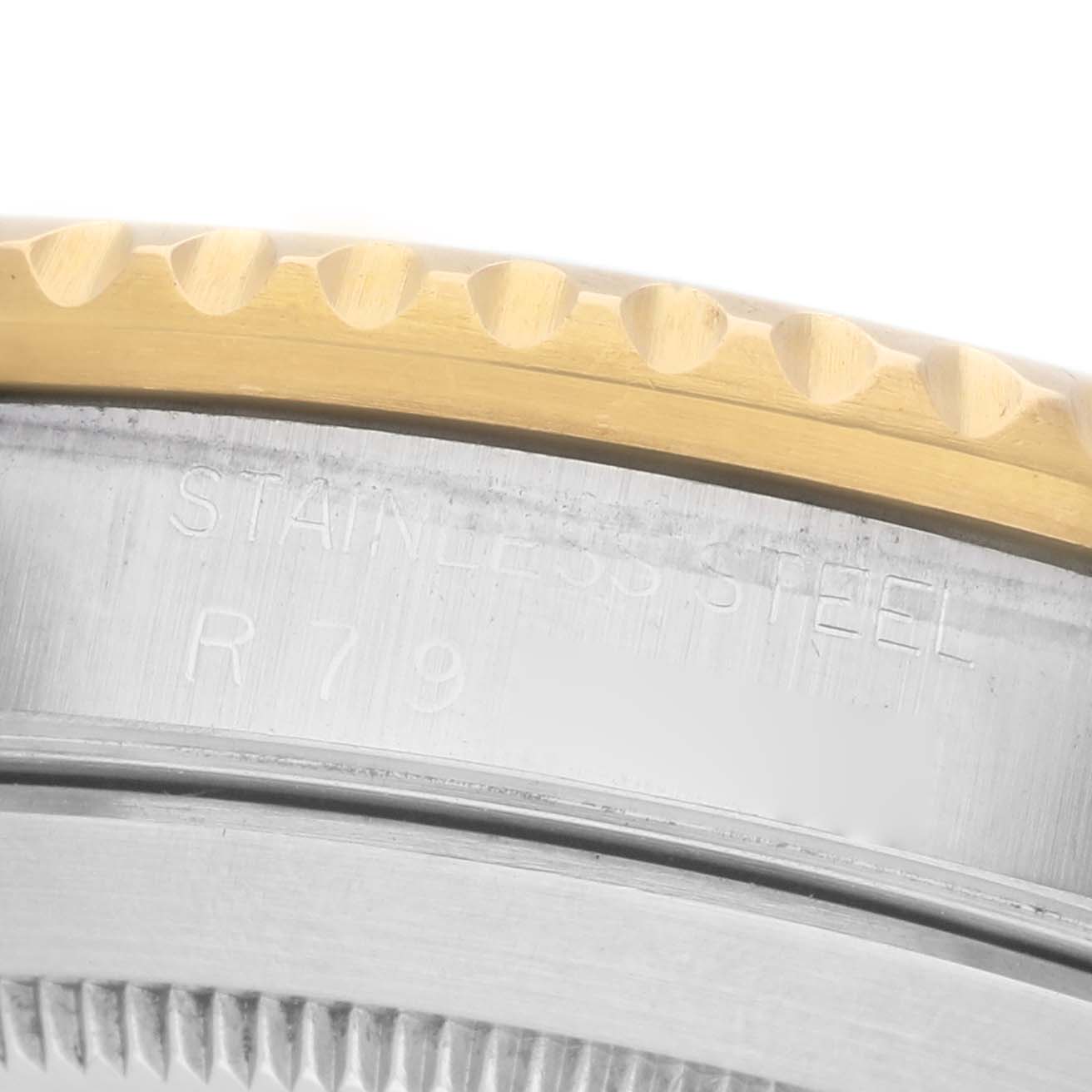 The image shows a close-up of the bezel and case side of a Rolex Submariner 16803 Men's Steel and Gold (two tone) Blue Dial, highlighting its edge detail.