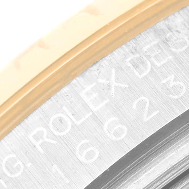 This close-up shows the side engraving and bezel of the Rolex Yacht-Master 16623 Men's Steel and Gold (two tone) Champagne Dial 16623 Men's Steel and Gold (two tone) Champagne Dial watch.