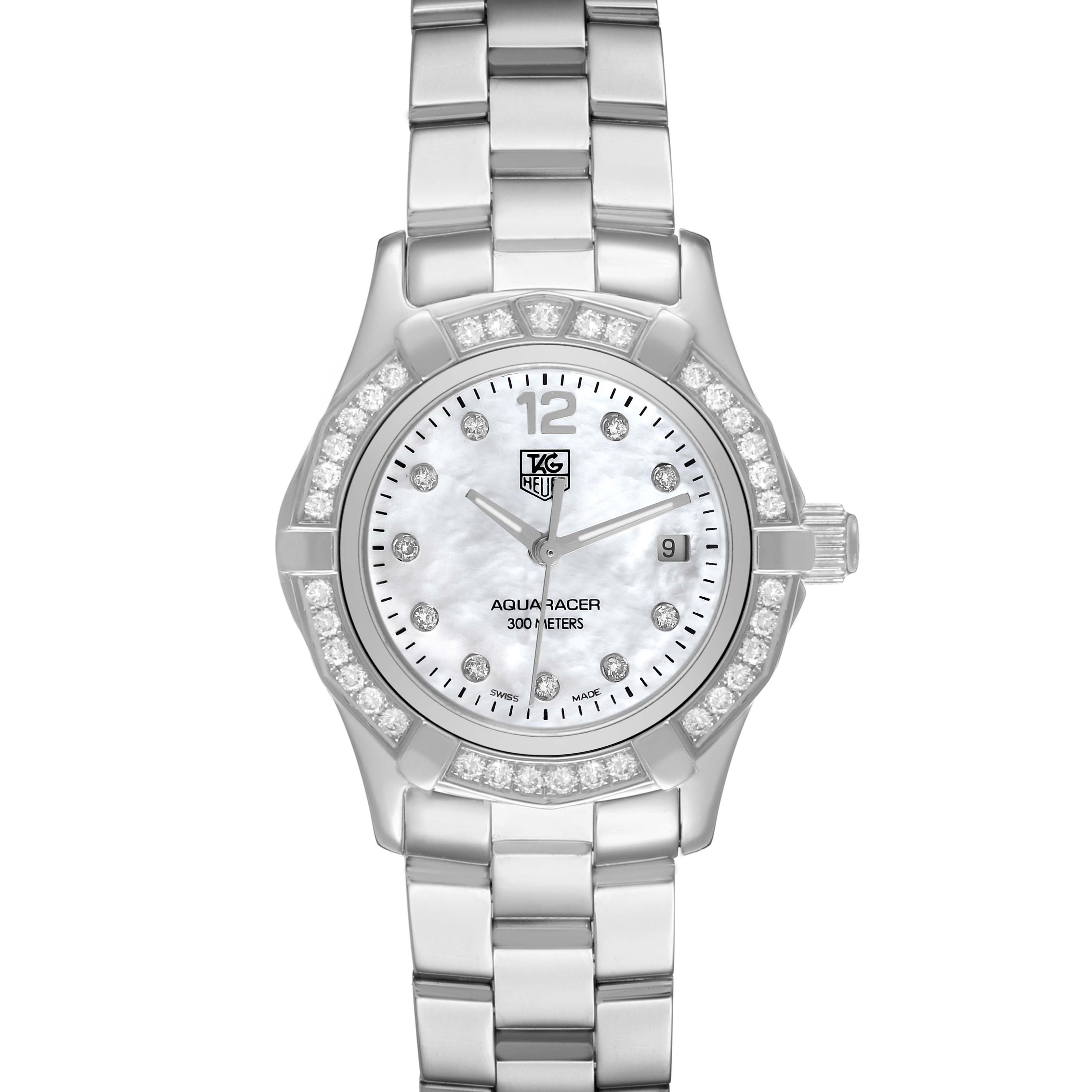 The TAG Heuer Aquaracer watch is shown from a top-down angle, highlighting its face, bezel, and metal bracelet.