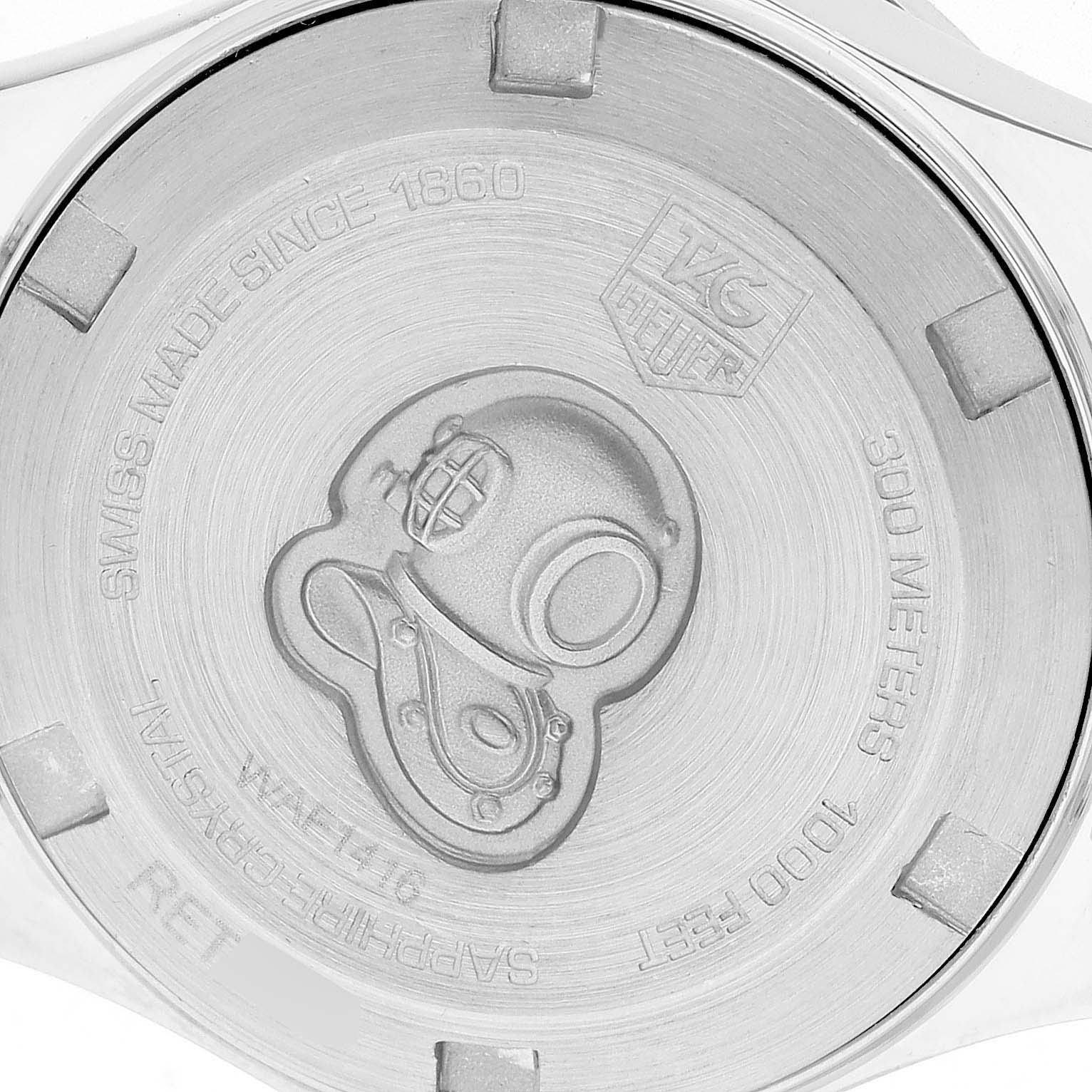 This image shows the back case of a Tag Heuer Aquaracer WAF1416 Women's Stainless Steel Mother of Pearl Dial, featuring the brand logo and a diving helmet engraving.
