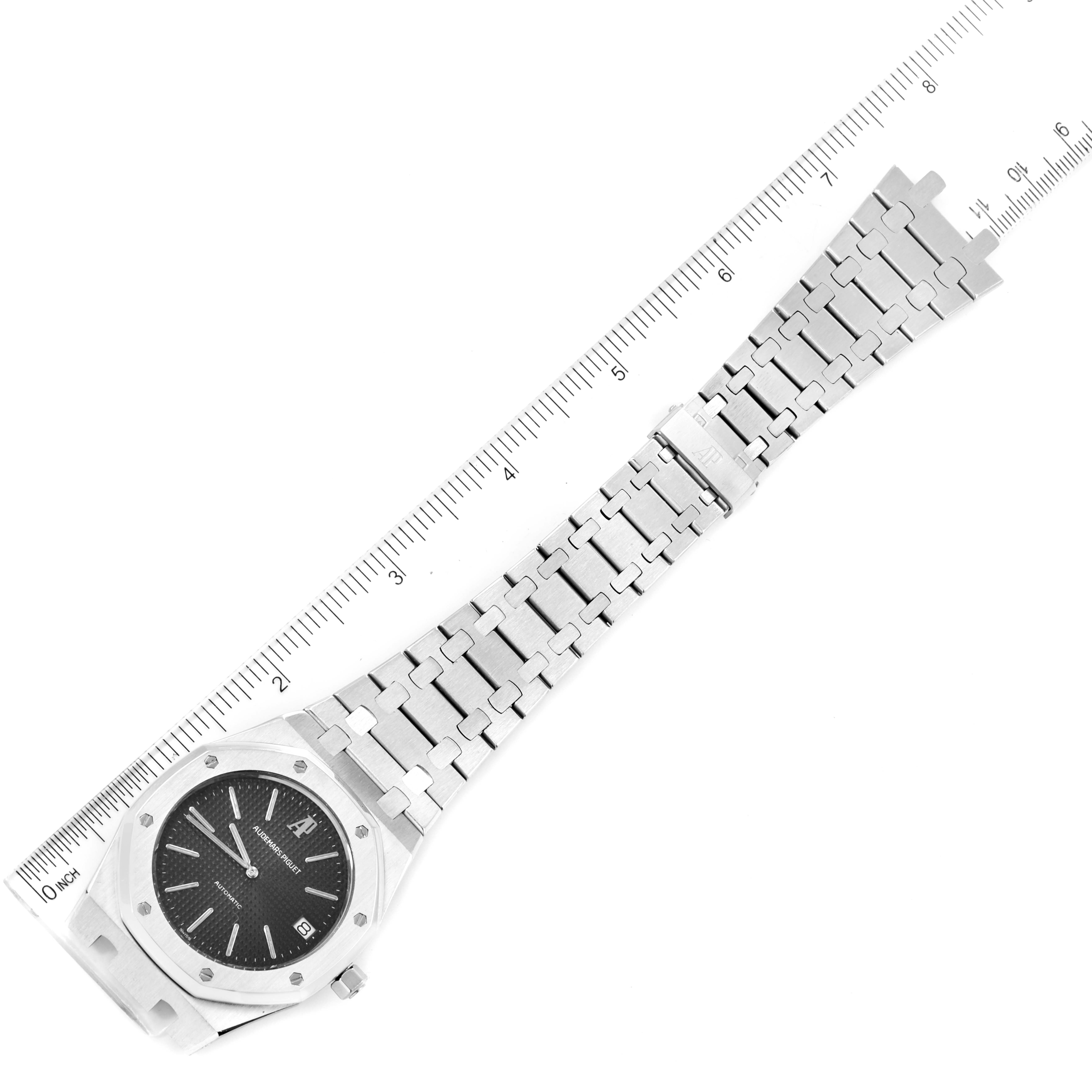 The image showcases a top-down view of the Audemars Piguet Royal Oak 5402ST Men's Stainless Steel Black Dial 5402ST Men's Stainless Steel Black Dial watch, highlighting the face, bracelet, and clasp alongside a ruler.