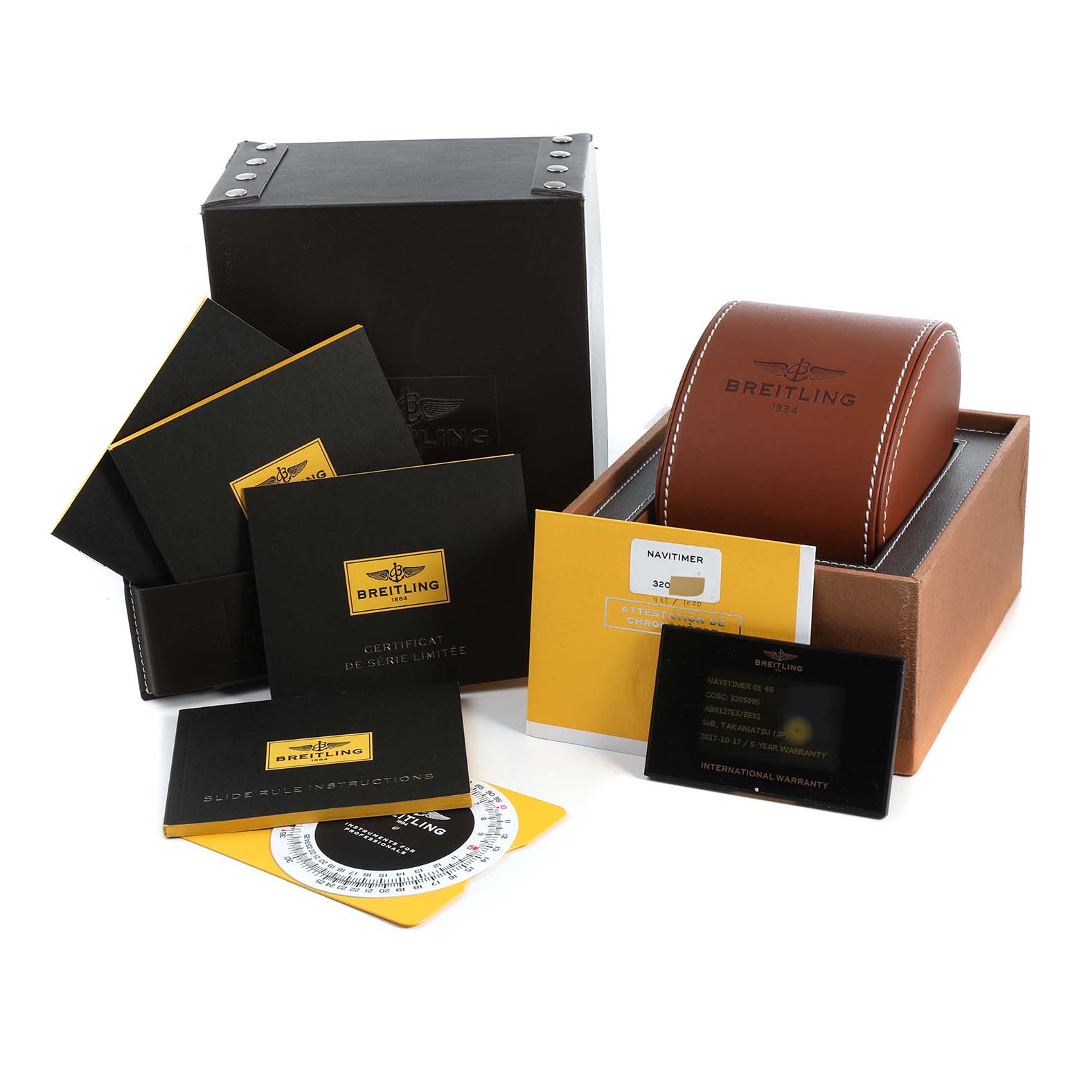 The image shows the Breitling Limited Series watch set, including the box, certificate, instruction manuals, and leather case.