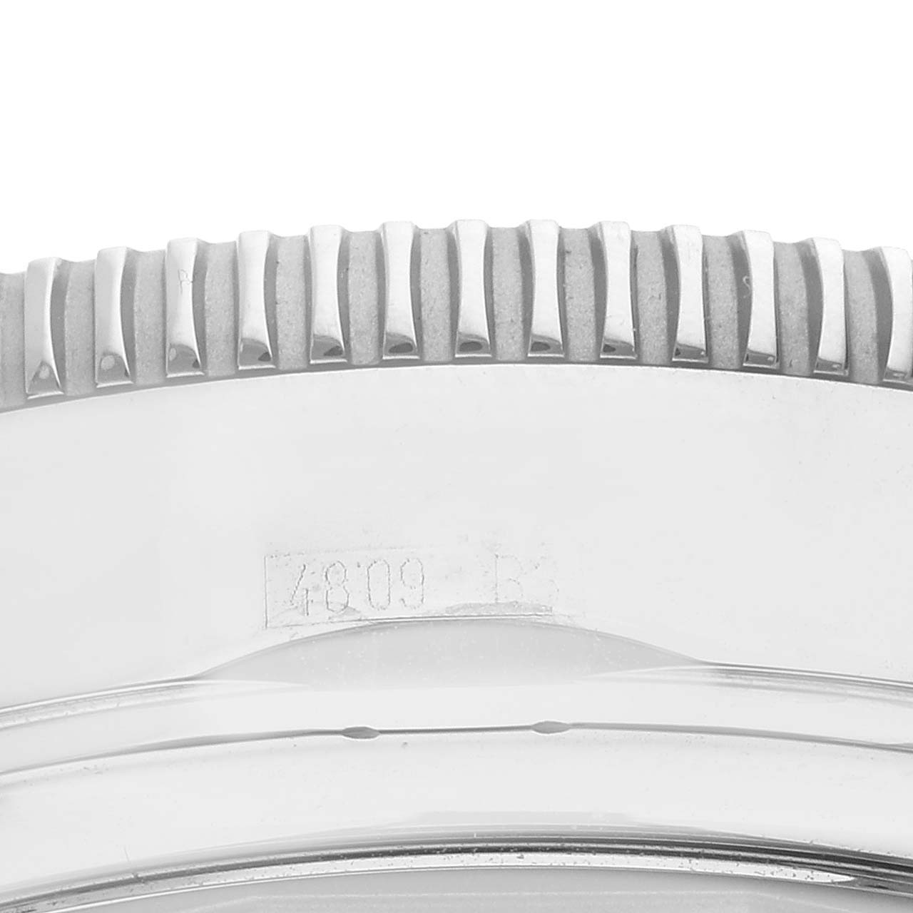 The image shows a close-up of the engraved bezel and part of the case back of a Limited Series model by Breitling.