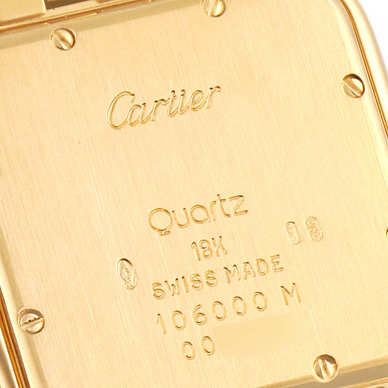 This image shows the back cover of a Cartier Panthere W25014B9 Men's Yellow Gold Silver Dial W25014B9 Men's Yellow Gold Silver Dial watch, displaying inscriptions and screws.