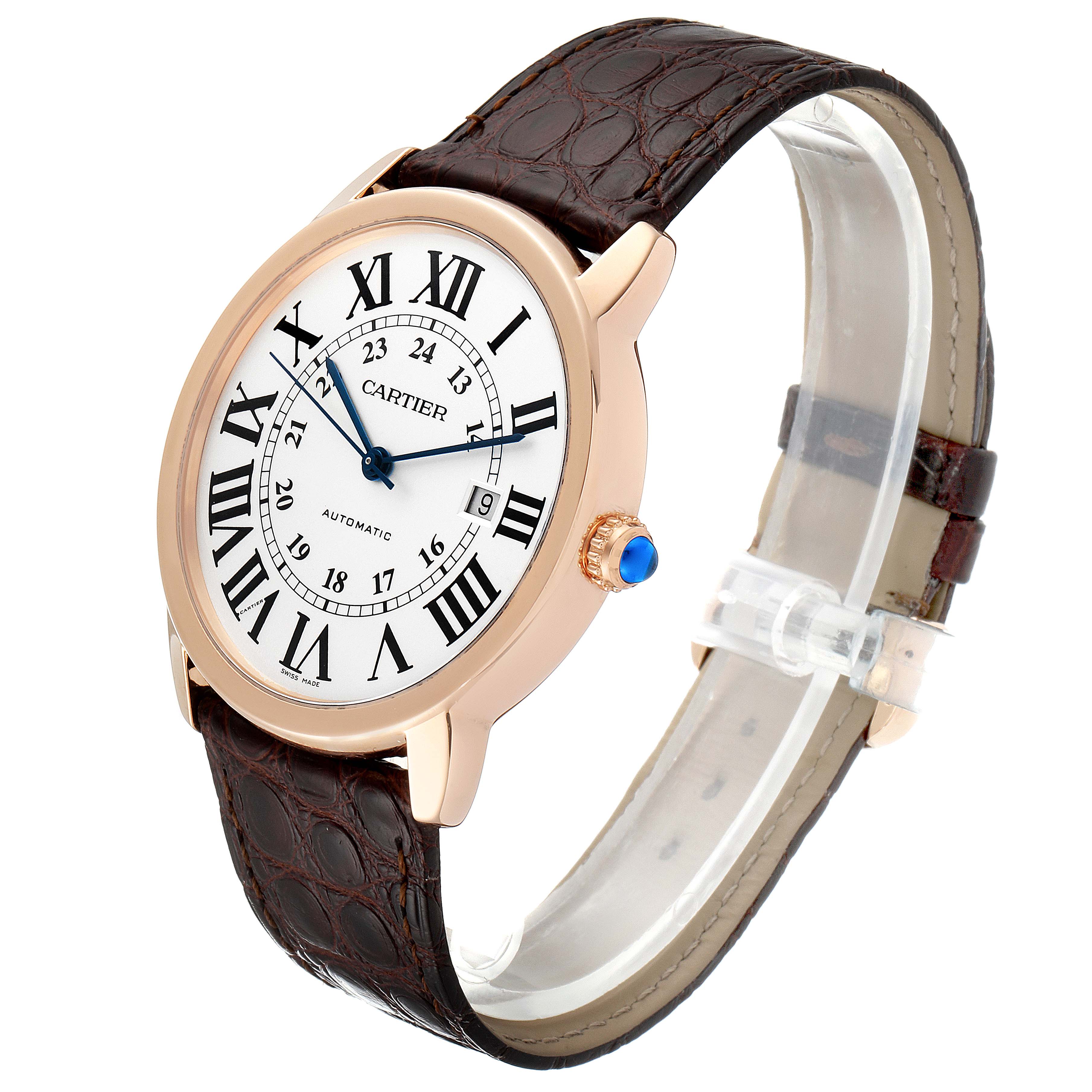 The Cartier Ronde W6701009 Men's Rose Gold Silver Dial W6701009 Men's Rose Gold Silver Dial watch is shown at a slight angle, displaying its face, brown leather strap, and crown with a blue cabochon.