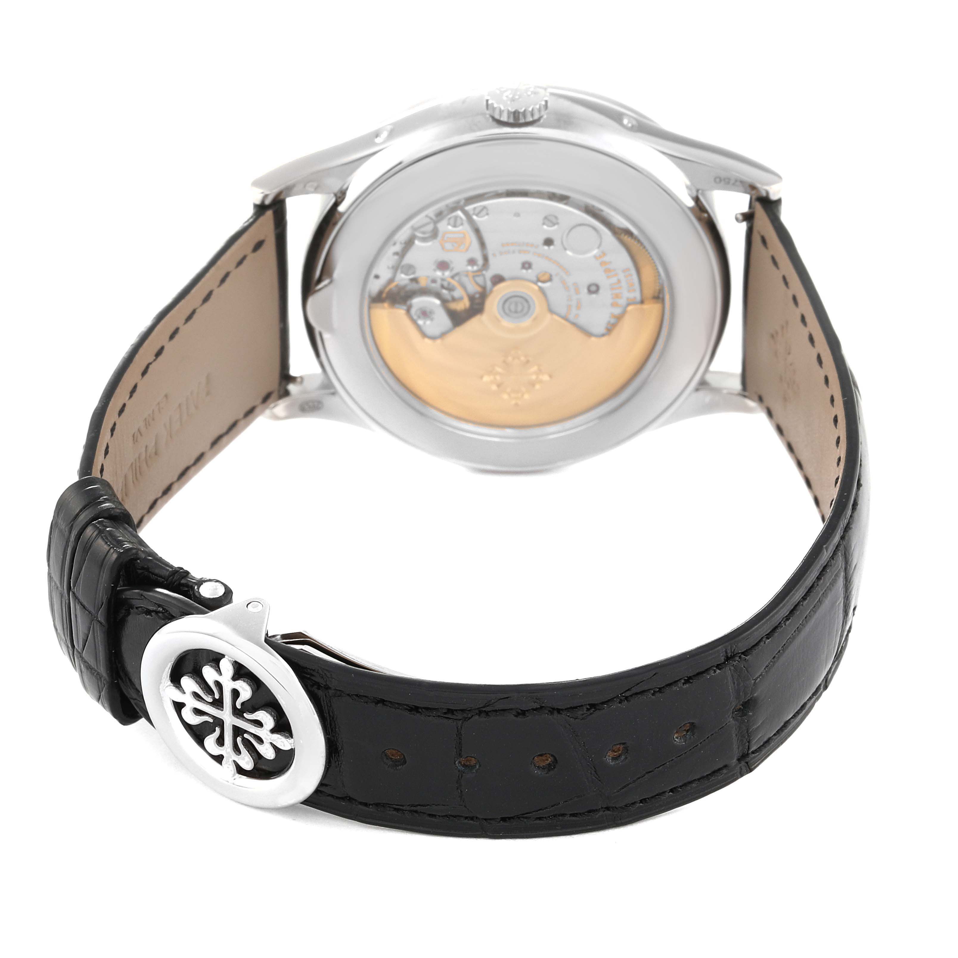 The image shows the back view of a Patek Philippe Complications 5396G - 011 Men
s White Gold Silver Dial 5396G - 011 Men
s White Gold Silver Dial watch, highlighting the movement and leather strap.