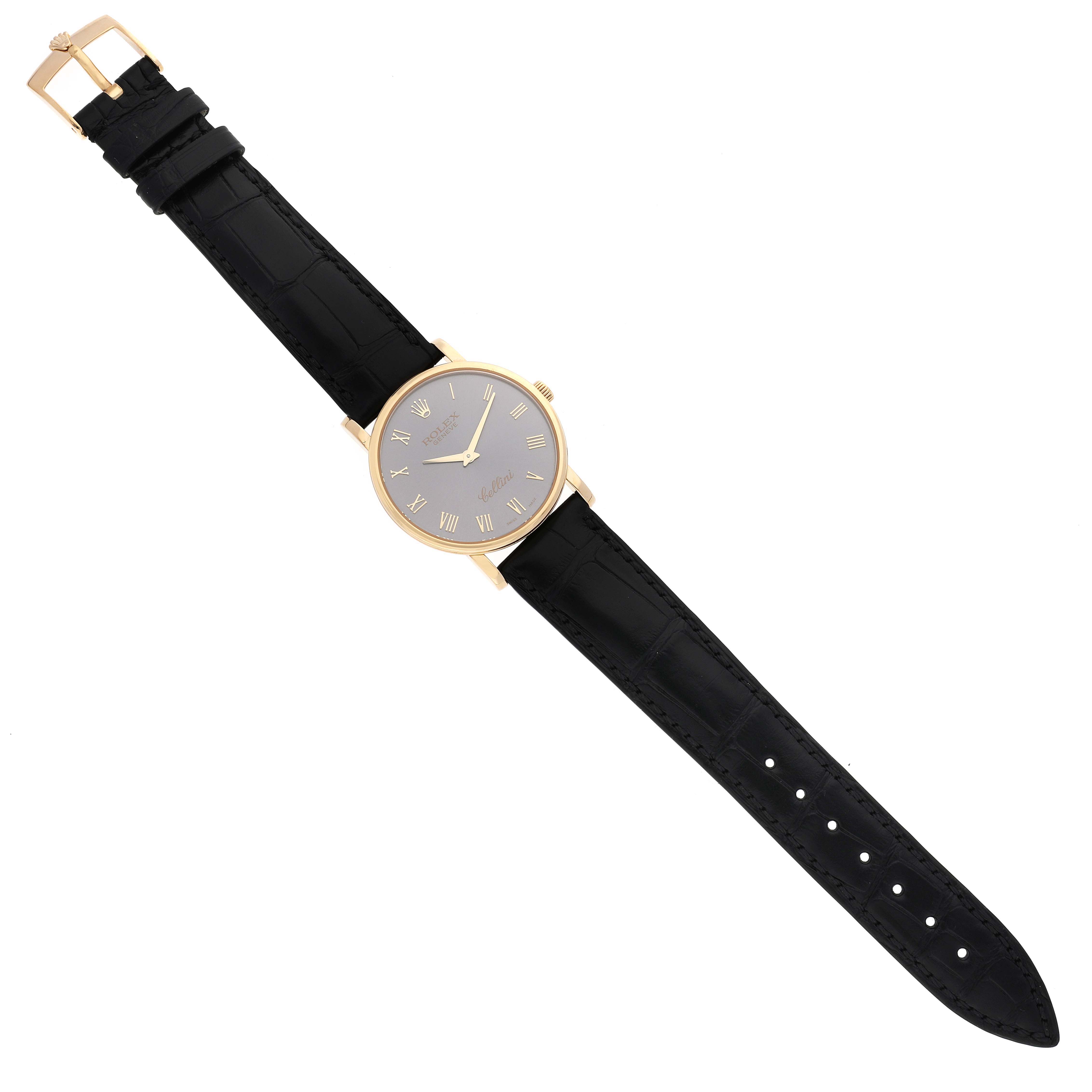 The image shows a Rolex Cellini 5115 Men's Yellow Gold Grey Dial 5115 Men's Yellow Gold Grey Dial watch from a top-down angle, highlighting its face, black leather strap, and gold clasp.