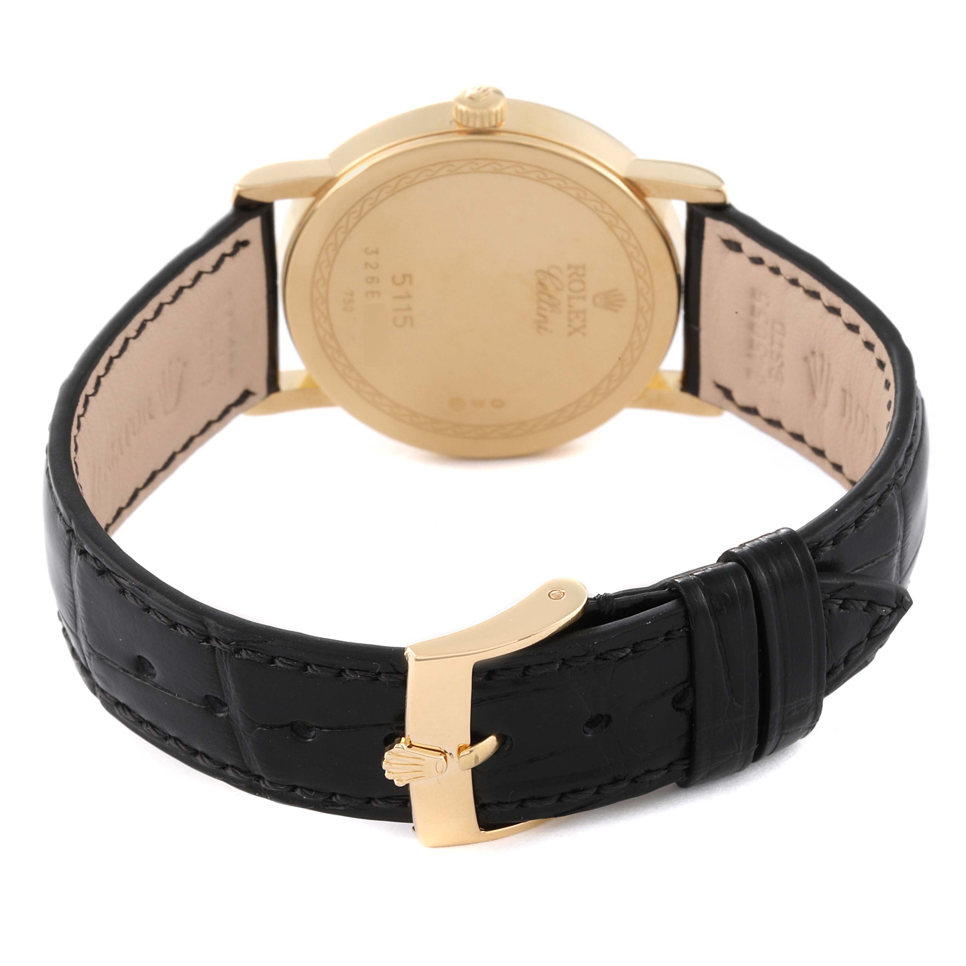 The image shows the backside of a Rolex Cellini 5115 Men's Yellow Gold Grey Dial 5115 Men's Yellow Gold Grey Dial watch, displaying the gold case back and the black leather strap with a gold buckle.