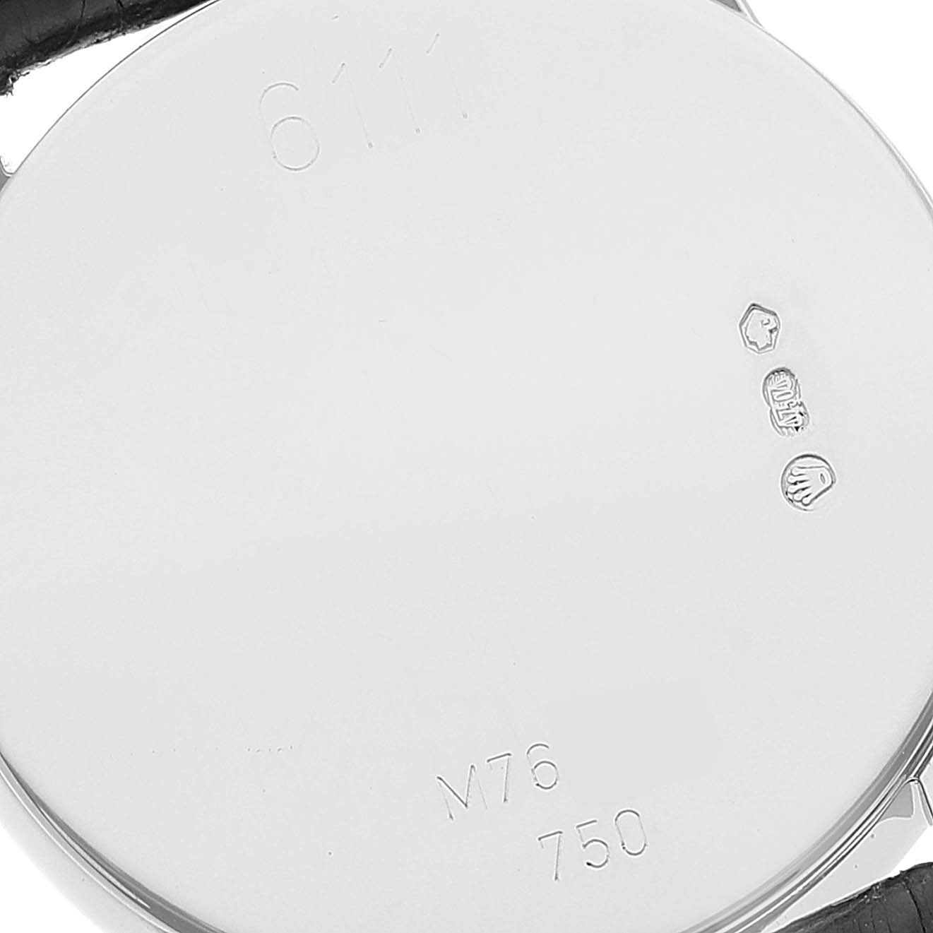 This image shows the back of a Rolex Cellini 6111/1 Women's White Gold Silver Dial 6111/1 Women's White Gold Silver Dial watch with engravings and hallmarks.