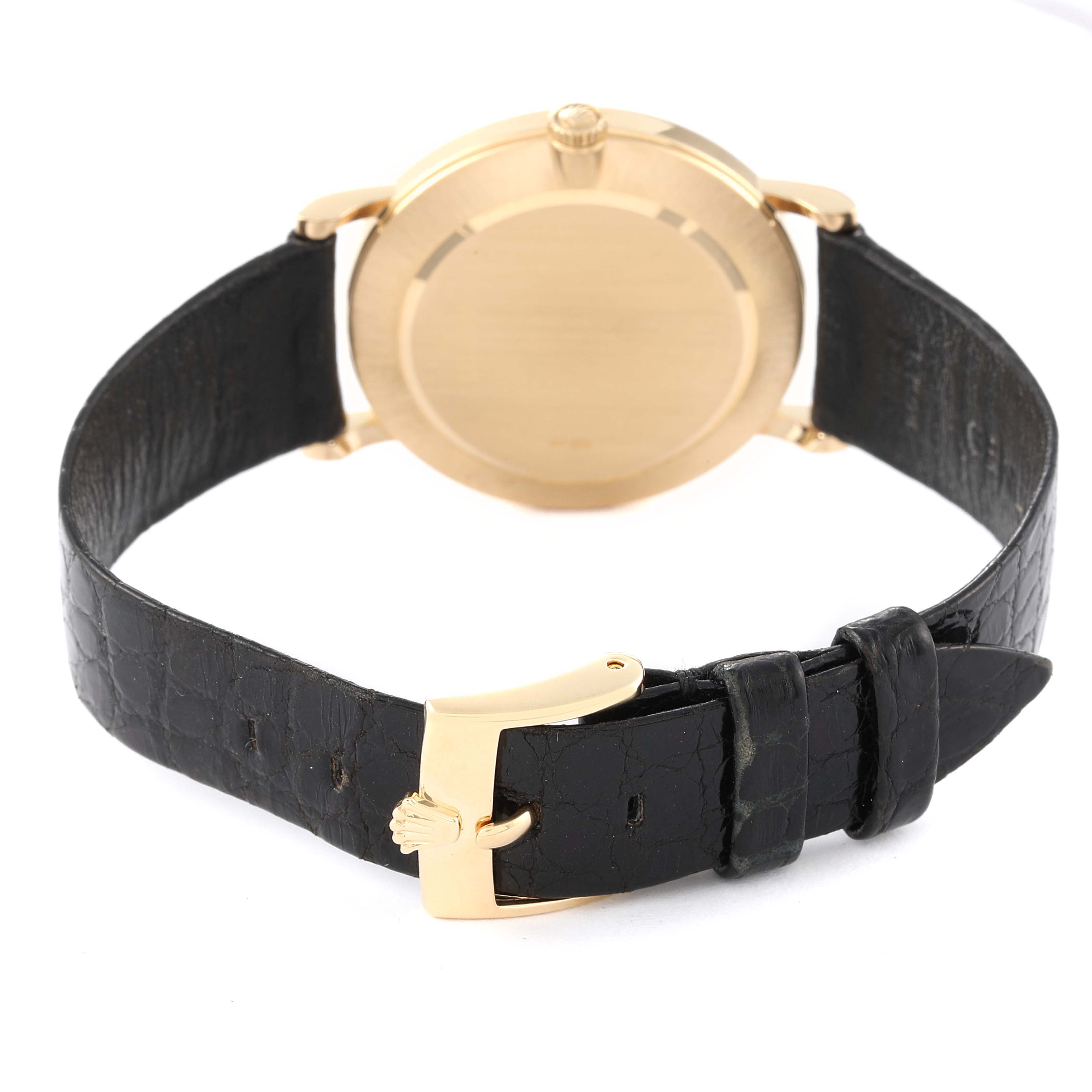 The image shows the back view of the Rolex Cellini 5112 Men's Yellow Gold Beige Dial 5112 Men's Yellow Gold Beige Dial watch, including its gold case and black leather strap with a gold buckle.