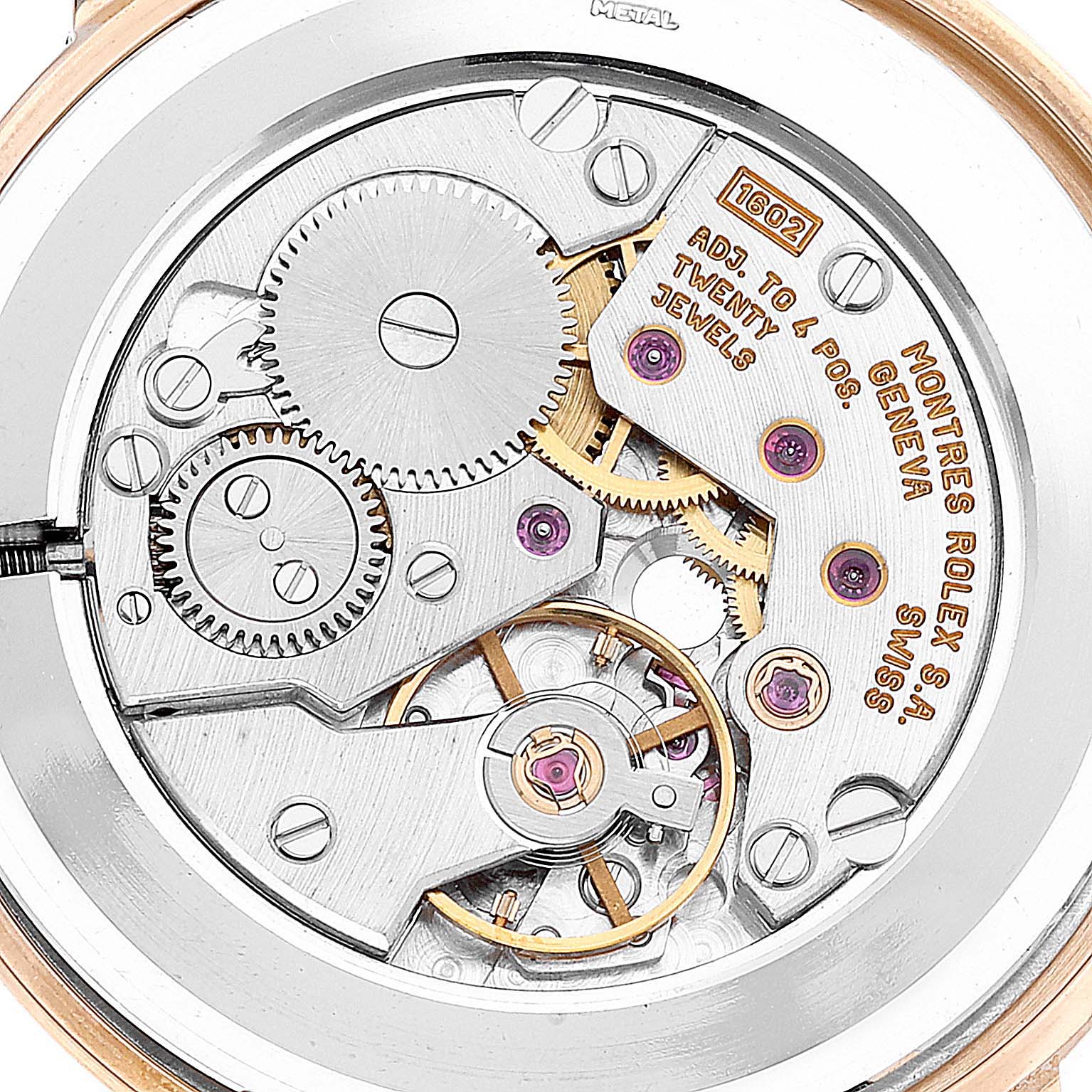 This image shows the intricate internal mechanism of the Rolex Cellini 5112 Men's Yellow Gold Beige Dial 5112 Men's Yellow Gold Beige Dial watch, highlighting its gears, jewels, and inscriptions.