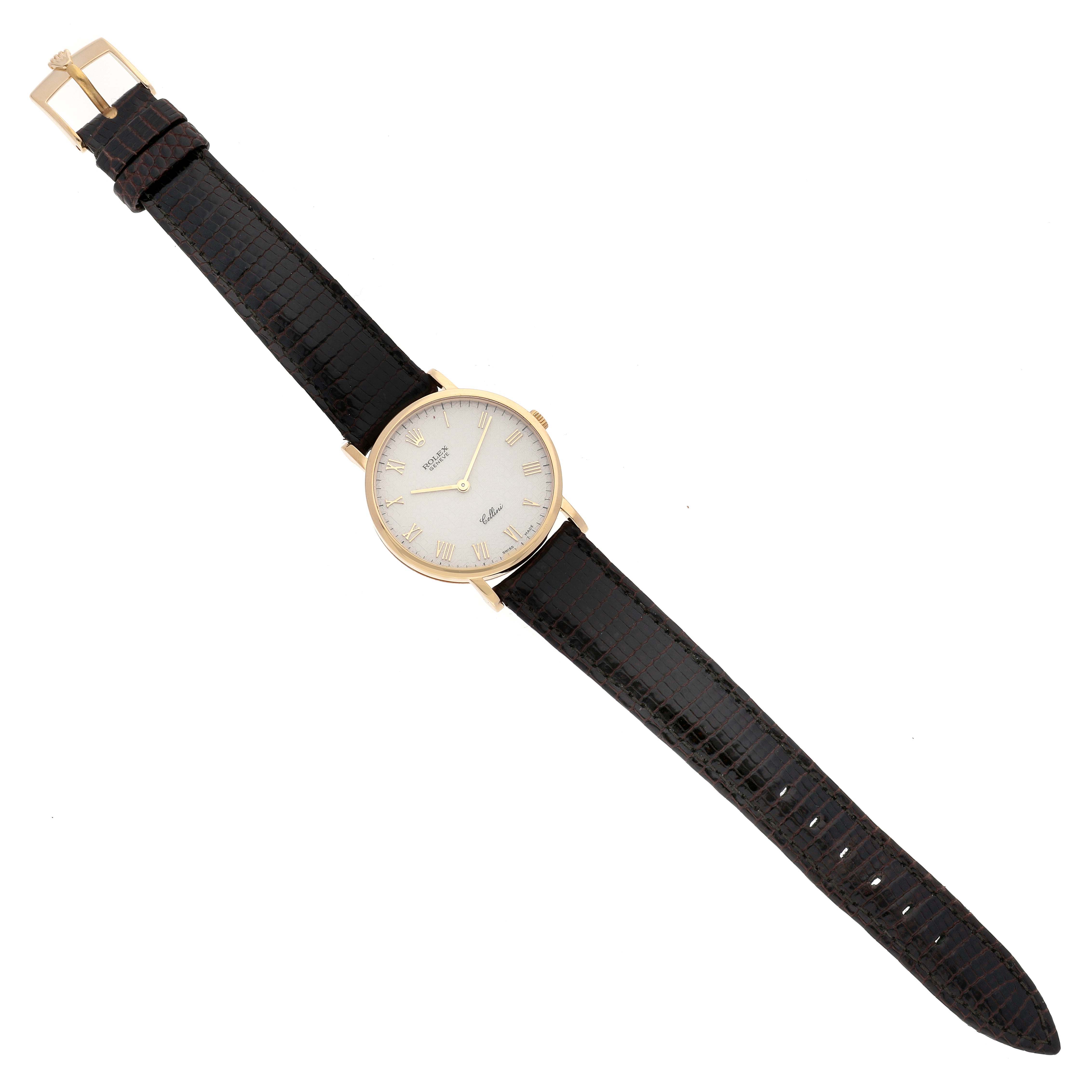 The Rolex Cellini 5112 Men's Yellow Gold Beige Dial 5112 Men's Yellow Gold Beige Dial watch is shown from a top-down angle, featuring its entire black leather strap and gold-tone case with a white dial.