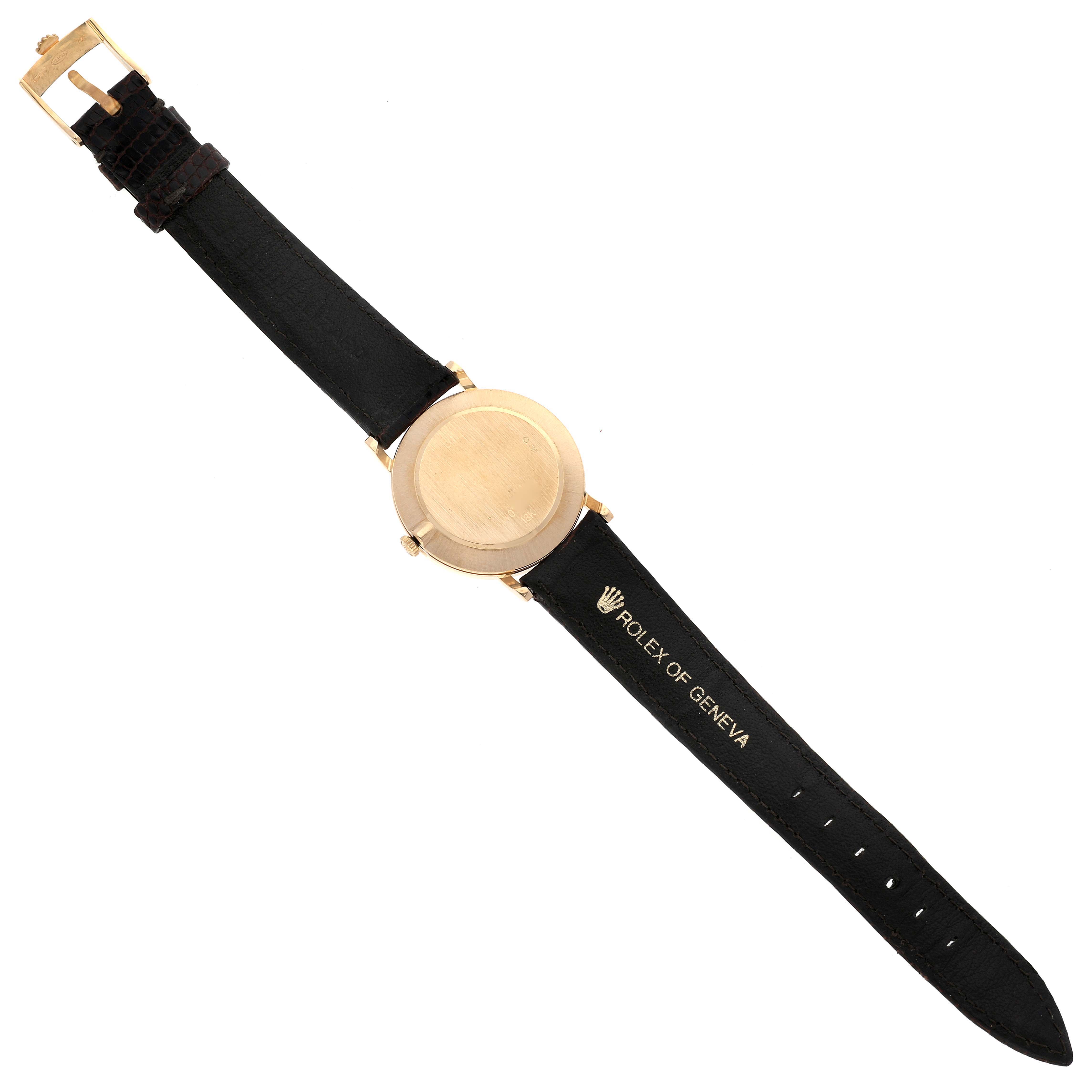 The Rolex Cellini 5112 Men's Yellow Gold Beige Dial 5112 Men's Yellow Gold Beige Dial watch is shown from the back, displaying the case and leather strap with the branding "Rolex of Geneva."