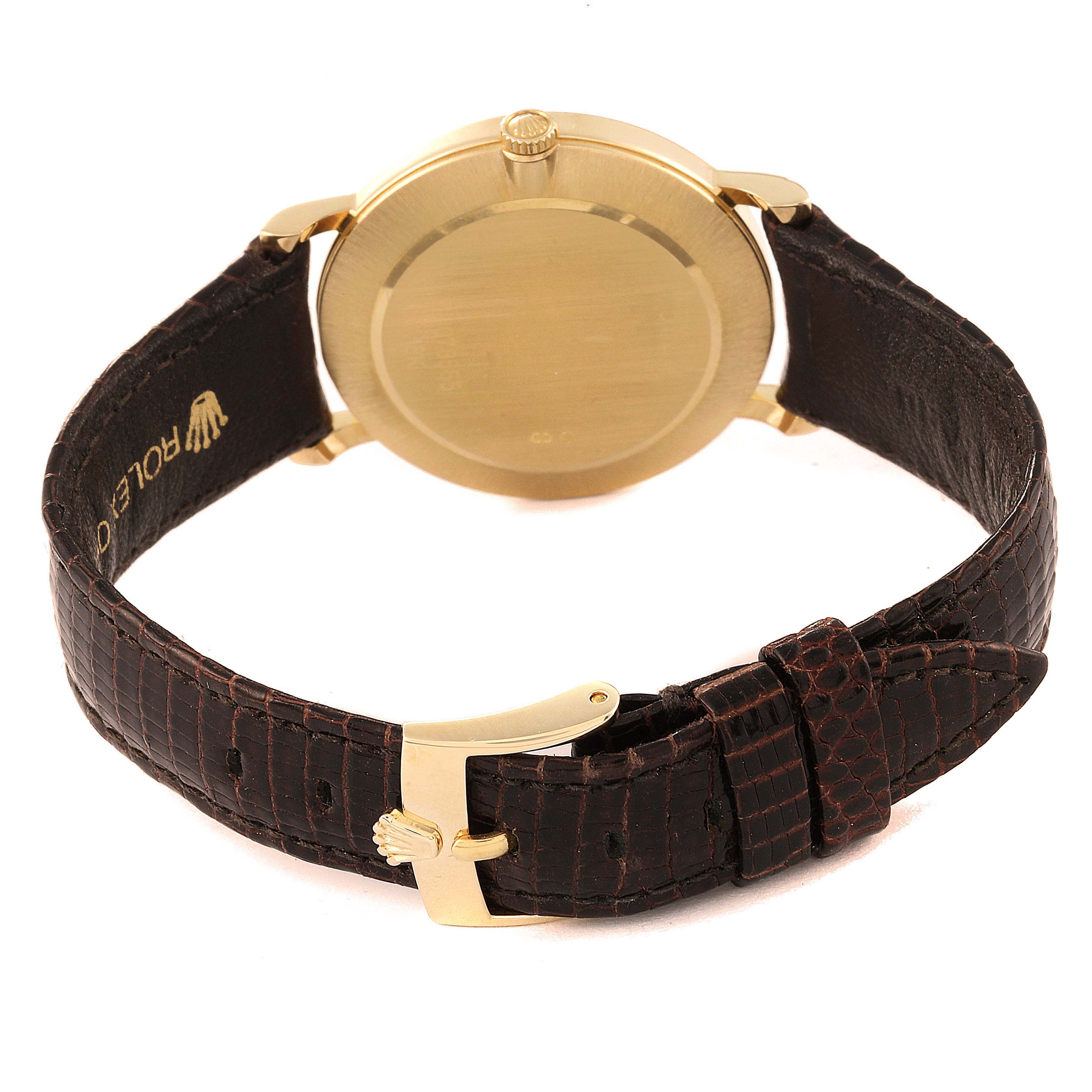 This image shows the back view of a Rolex Cellini 5112 Men's Yellow Gold Beige Dial 5112 Men's Yellow Gold Beige Dial watch, showcasing its case back and brown leather strap with a gold buckle.