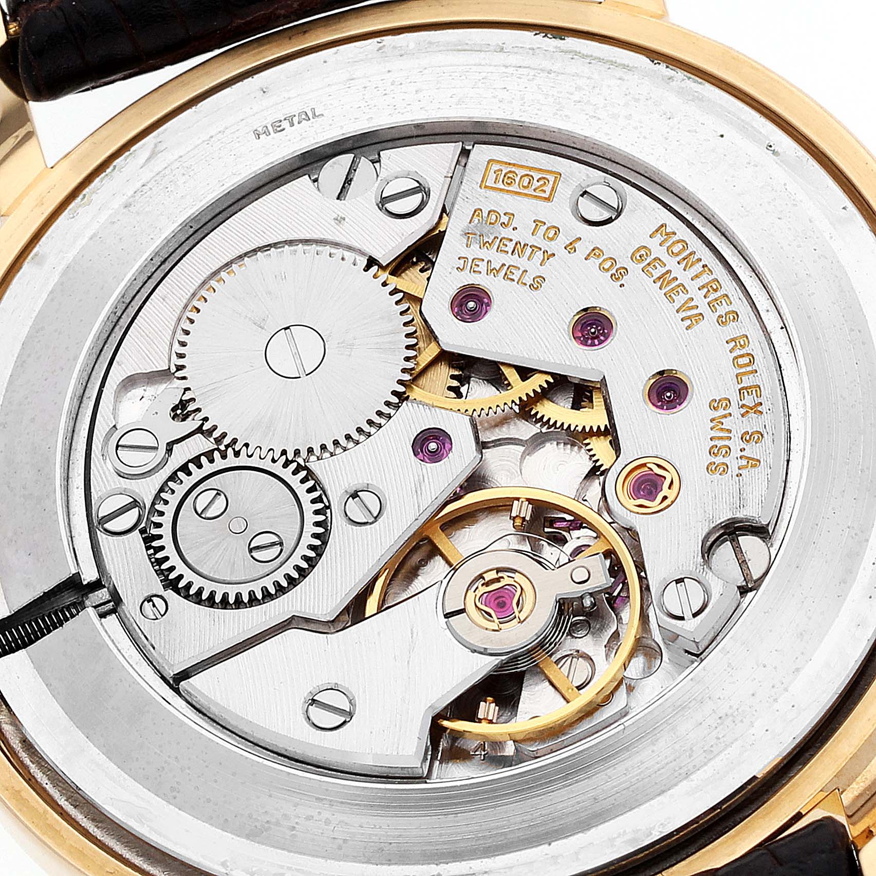 This image shows the internal movement mechanism of a Rolex Cellini 5112 Men's Yellow Gold Beige Dial 5112 Men's Yellow Gold Beige Dial watch, highlighting gears, jewels, and engravings.