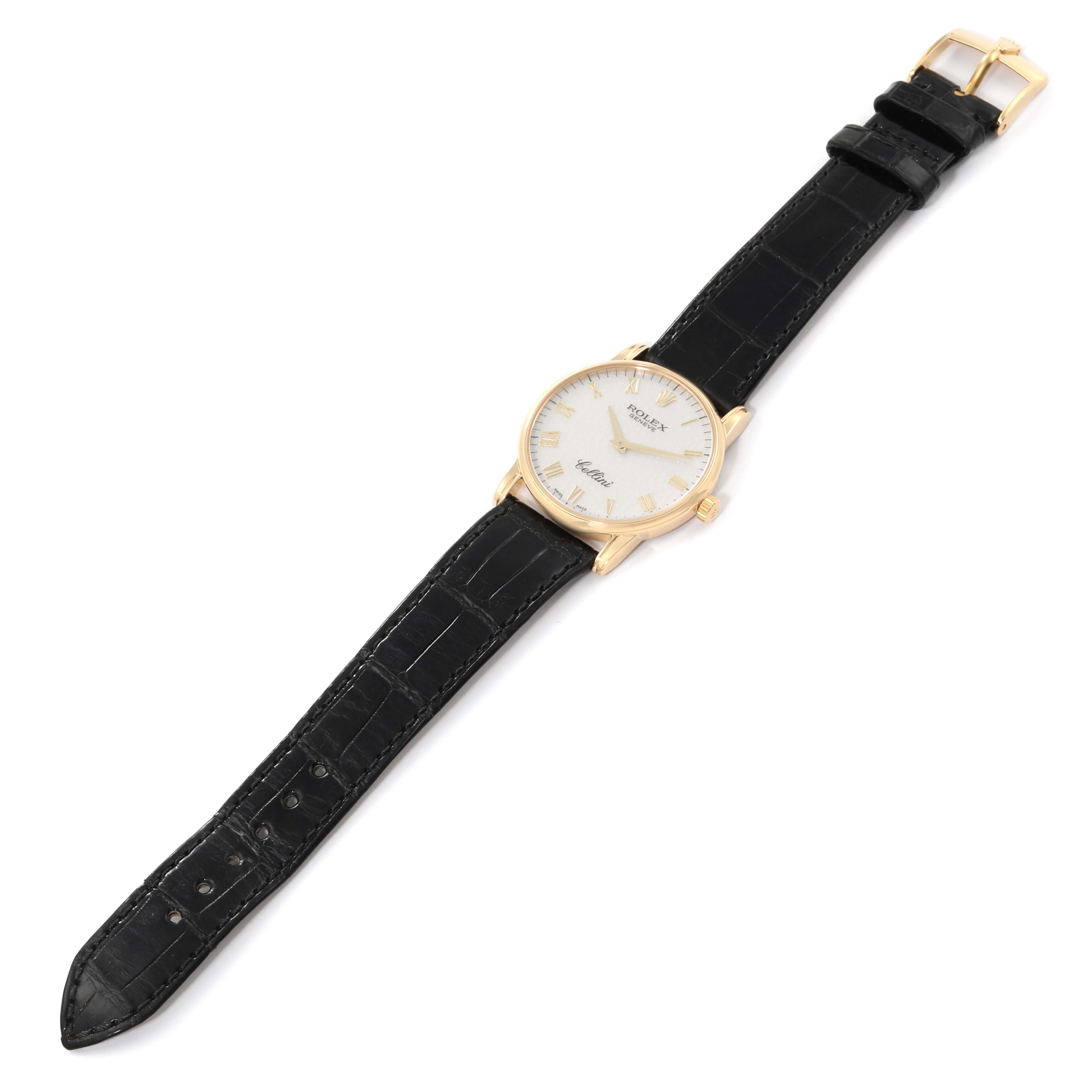 The Rolex Cellini 5116 Men's Yellow Gold White Dial 5116 Men's Yellow Gold White Dial watch is shown from a top view, displaying its face, black leather strap, and gold buckle.