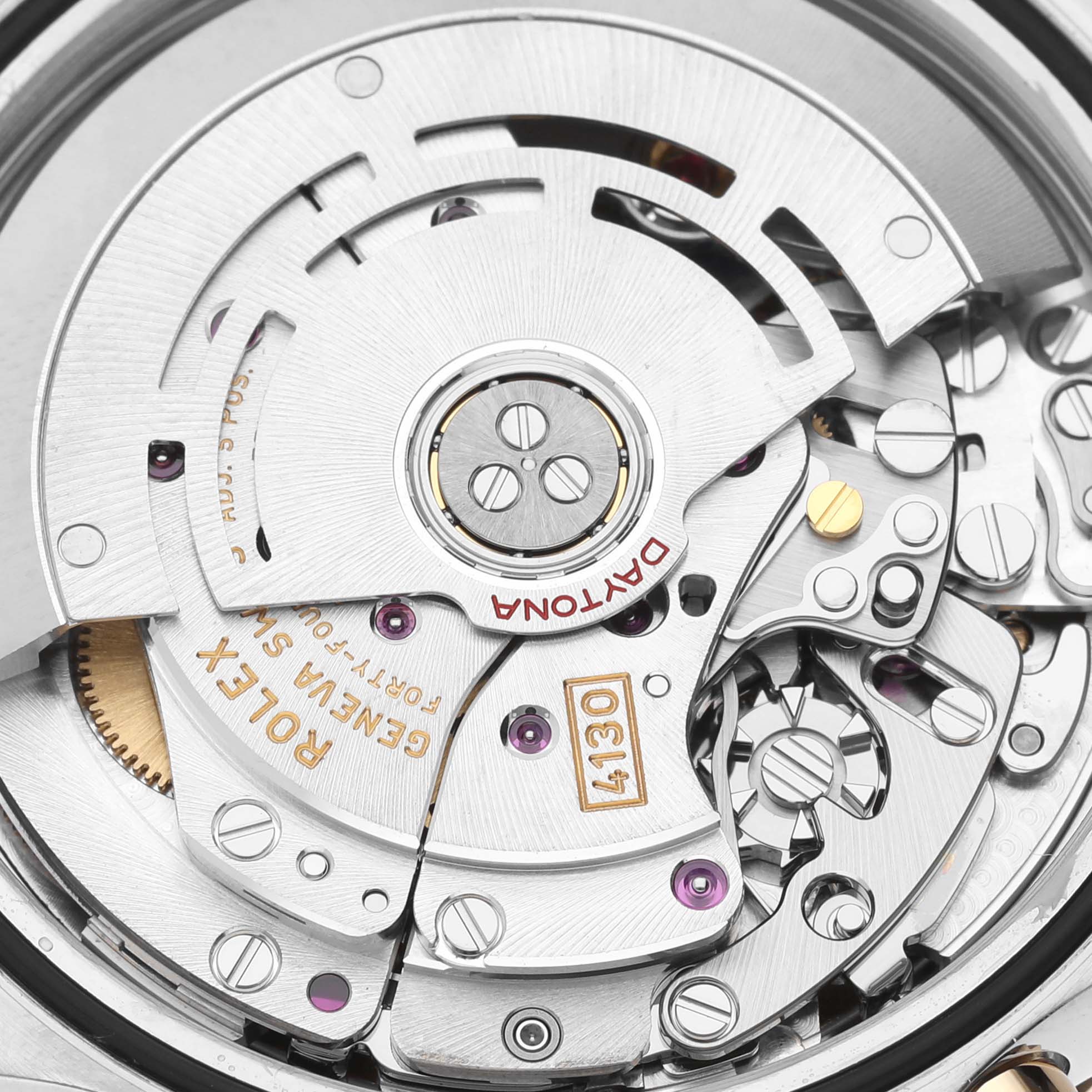 Close-up of the internal mechanics and movement parts of a Rolex Daytona 116503 Men's Steel and Gold (two tone) White Dial 116503 Men's Steel and Gold (two tone) White Dial watch, showcasing intricate components and engravings.