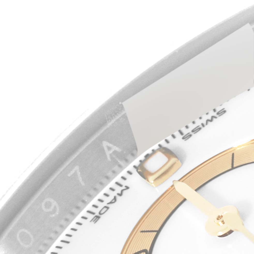 This image shows a close-up of the dial and part of the bezel of a Rolex Daytona 116503 Men's Steel and Gold (two tone) White Dial 116503 Men's Steel and Gold (two tone) White Dial watch.