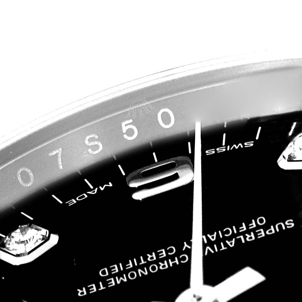 This close-up shows the dial, hands, and part of the 9 o'clock marker on the Rolex Date 115234 Men's Stainless Steel Black Dial 115234 Men's Stainless Steel Black Dial model.