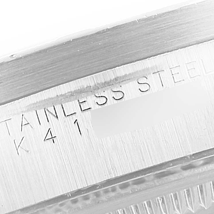 The image shows a close-up of the case side and serial number of the Rolex Date 15210 Men's Stainless Steel Blue Dial 15210 Men's Stainless Steel Blue Dial model, engraved on stainless steel.