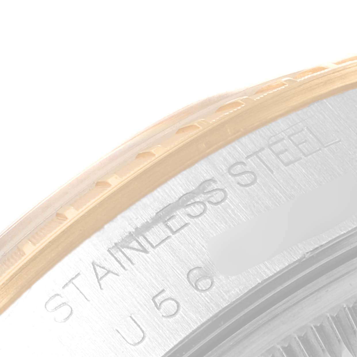 This is a close-up of the side view showing the engraved text on a Rolex Date 15223 Men's Steel and Gold (two tone) Blue Dial 15223 Men's Steel and Gold (two tone) Blue Dial model's stainless steel caseback.