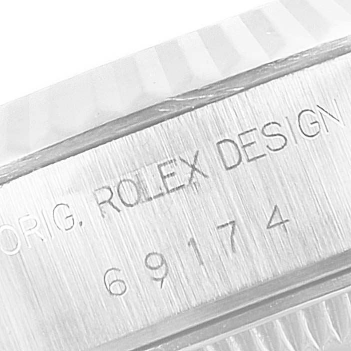 This close-up image shows the serial and model number engraved on the case side of the Rolex Datejust 69174 Women
s Stainless Steel White Dial 69174 Women
s Stainless Steel White Dial watch.