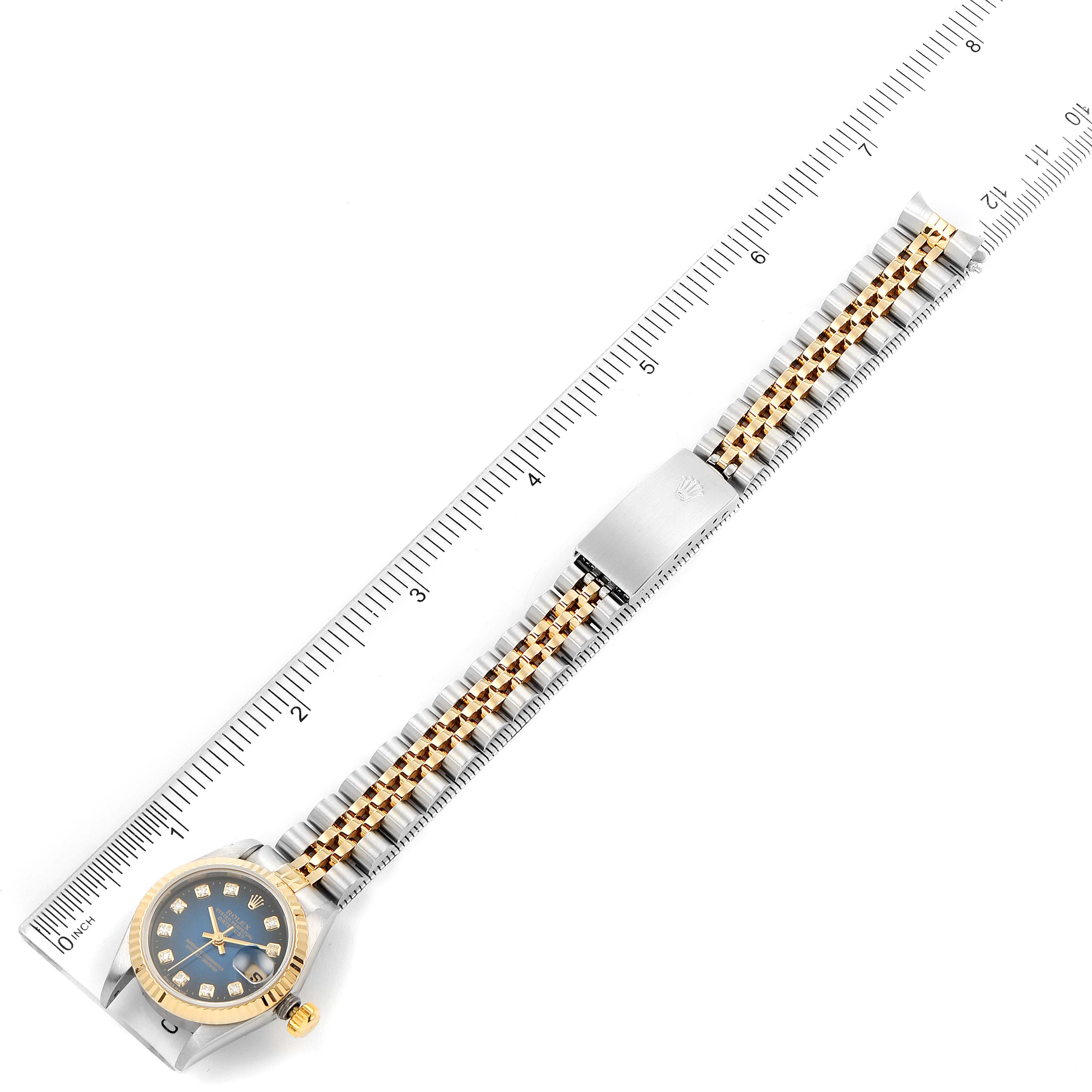 This image shows a flat-lay view of an entire Rolex Datejust 69173 Women's Steel and Gold (two tone) Blue Dial 69173 Women's Steel and Gold (two tone) Blue Dial watch with its full bracelet against a ruler for scale.