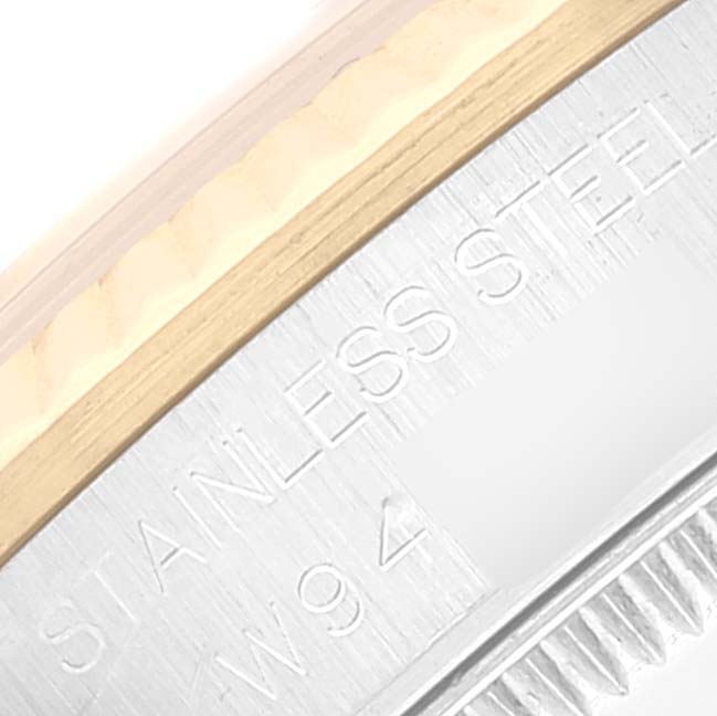 This image displays a close-up of the case back edge featuring engravings on the Mid-Size Rolex.