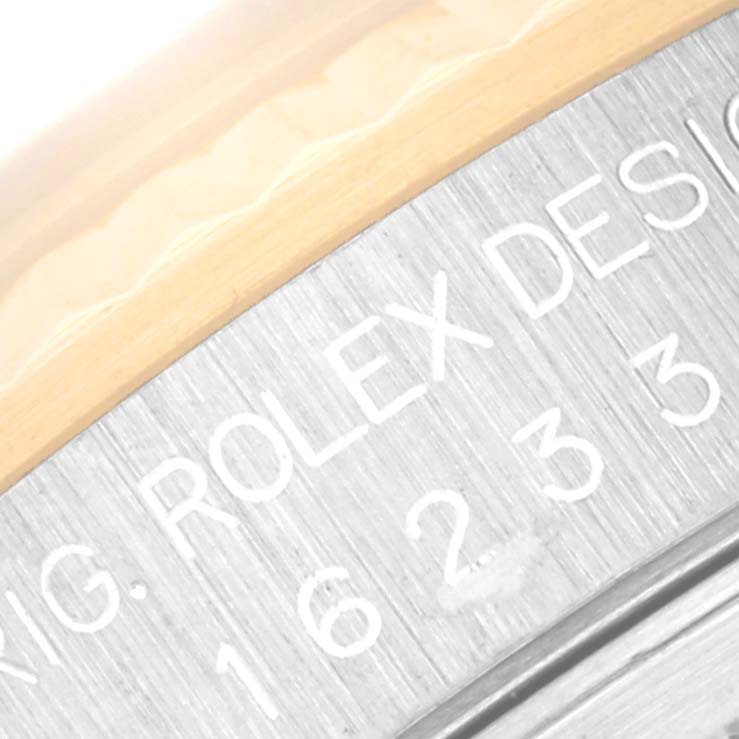 The image shows a close-up of the engraved text on the caseback edge of a Rolex Datejust 16233 Men's Steel and Gold (two tone) Black Dial 16233 Men's Steel and Gold (two tone) Black Dial watch.