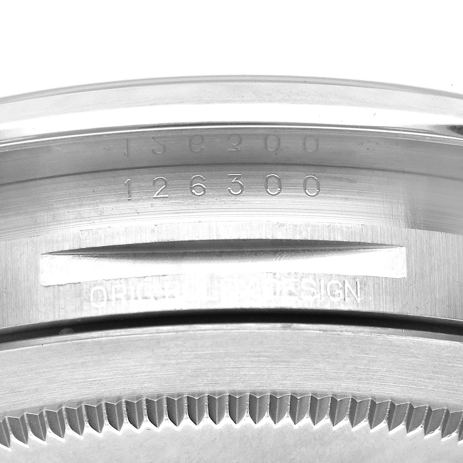This image shows the serial number and part of the case back of a Rolex Datejust 41 126300 Men
s Stainless Steel Blue Dial 126300 Men
s Stainless Steel Blue Dial model at a close-up angle.
