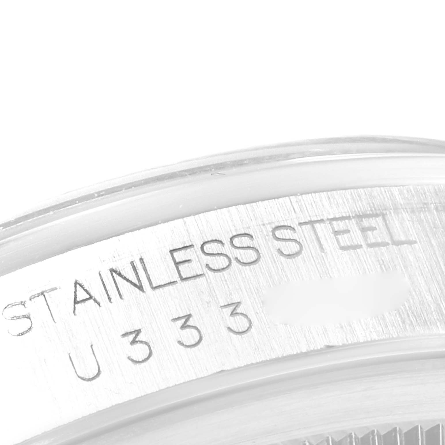 This image shows a close-up of the case back engraving on a Rolex Datejust 16200 Men's Stainless Steel Silver Dial 16200 Men's Stainless Steel Silver Dial watch, indicating "STAINLESS STEEL" and a serial number.