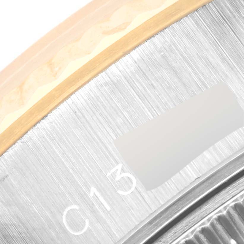 The image shows a close-up of the bezel and part of the casing of a Rolex Datejust 69173 Women's Steel and Gold (two tone) Champagne Dial 69173 Women's Steel and Gold (two tone) Champagne Dial watch.
