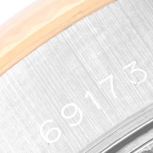 This is a close-up of the Rolex Datejust 69173 Women's Steel and Gold (two tone) Champagne Dial 69173 Women's Steel and Gold (two tone) Champagne Dial model, focusing on the serial number engraved on the metallic case.