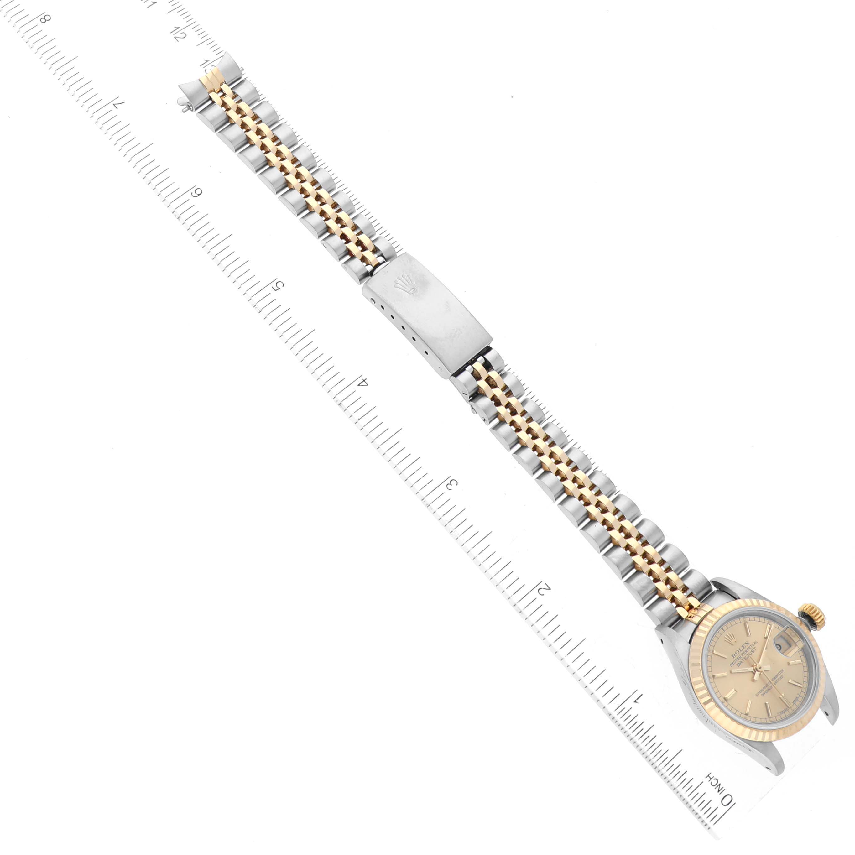 The image shows a Rolex Datejust 69173 Women's Steel and Gold (two tone) Champagne Dial 69173 Women's Steel and Gold (two tone) Champagne Dial watch laid flat, with its two-tone bracelet and clasp extended alongside a ruler.
